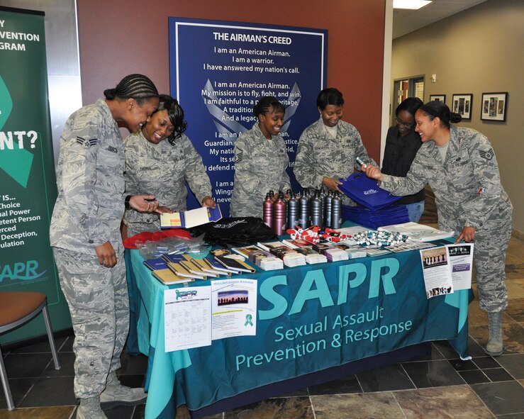 Air Reserve Personnel Center Sexual Assault Prevention and Response representatives Master Sgt. Joi Pearson, Tech. Sgt. Wynetta Thomas and Tech. Sgt. Letitia Edwards discuss items they have to offer during Sexual Assault Awareness Month with Nicole Johnson, Staff Sergeant Tiffany Hartman and Senior Airman Iliah Duncan April 7, 2015, on Buckley Air Force Base, Colo. SAPR representatives bring awareness and are available to provide assistance to ARPC professionals. (U.S. Air Force photo/Cindy Dewey)