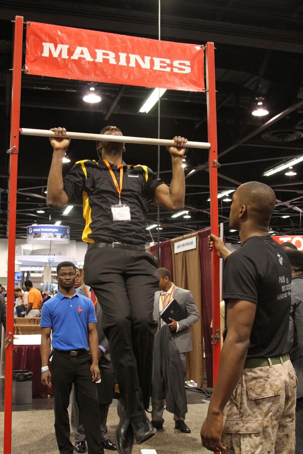 Sgt. Courtney Swinney, a Marine recruiter from Recruiting Station Orange County, observes as a National Society of Black Engineers career fair attendee participates in a Pull-up Challenge at the Marine Corps booth during the 2015 NSBE Convention March 27, 2015. Investing in a diverse and representative officer corps will help generate and sustain a future force that has cultural expertise, language skill sets and a variety of philosophies needed to meet operational requirements in the Marines. It was also an opportunity to reinforce the idea of the armed forces as viable career option within the African-American community.
