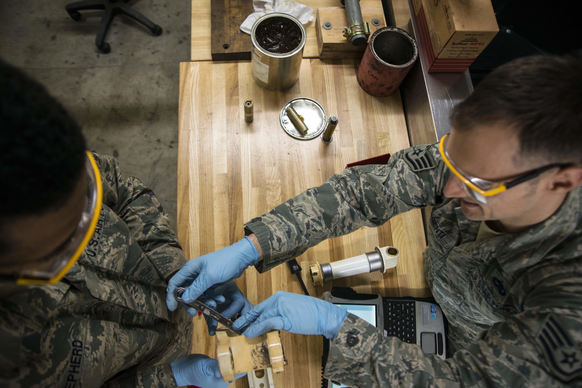 Senior Airman Rodney Shepherd and Staff Sgt. Brian Argenti, 35th Maintenance Squadron hydraulics systems maintainers, repair an F-16 Fighting Falcon's landing gear system March 31, 2015, at Misawa Air Base, Japan. As back shop maintainers, the duo repairs parts brought to them from crew chiefs on the flightline. Once a part is repaired, it is qualified for use on any F-16 across the Air Force. (U.S. Air Force photo/Staff Sgt. Derek VanHorn)