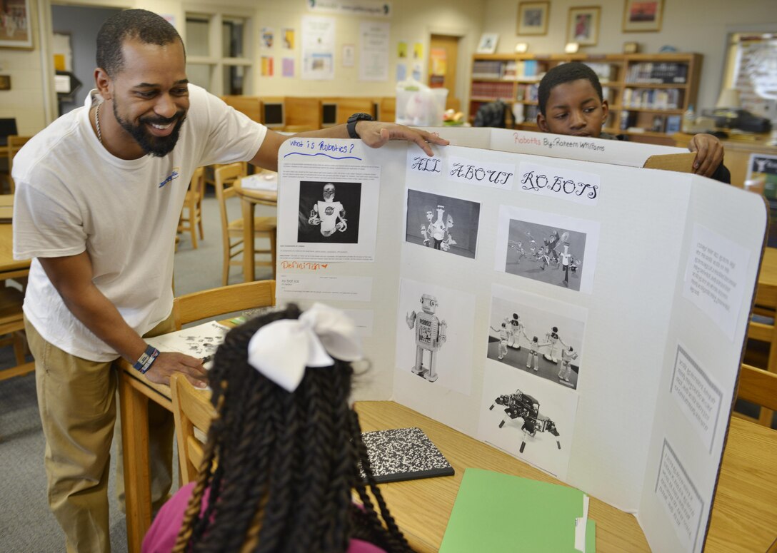 Canton Gardenhire, Corps Internal Review specialist, helps prepare sixth-grade student Jabria for a robotics presentation April 1 at DeRenne Middle School in Savannah. Gardenhire devotes two Wednesdays each month collaborating with students on projects covering physics, chemistry sciences, technology, engineering, mathematics operations and applications and STEM careers.  The Starbase program is a Department of Defense educational initiative designed to expose at-risk youth to the science, technology, engineering and math (STEM) disciplines, both on and off military installations