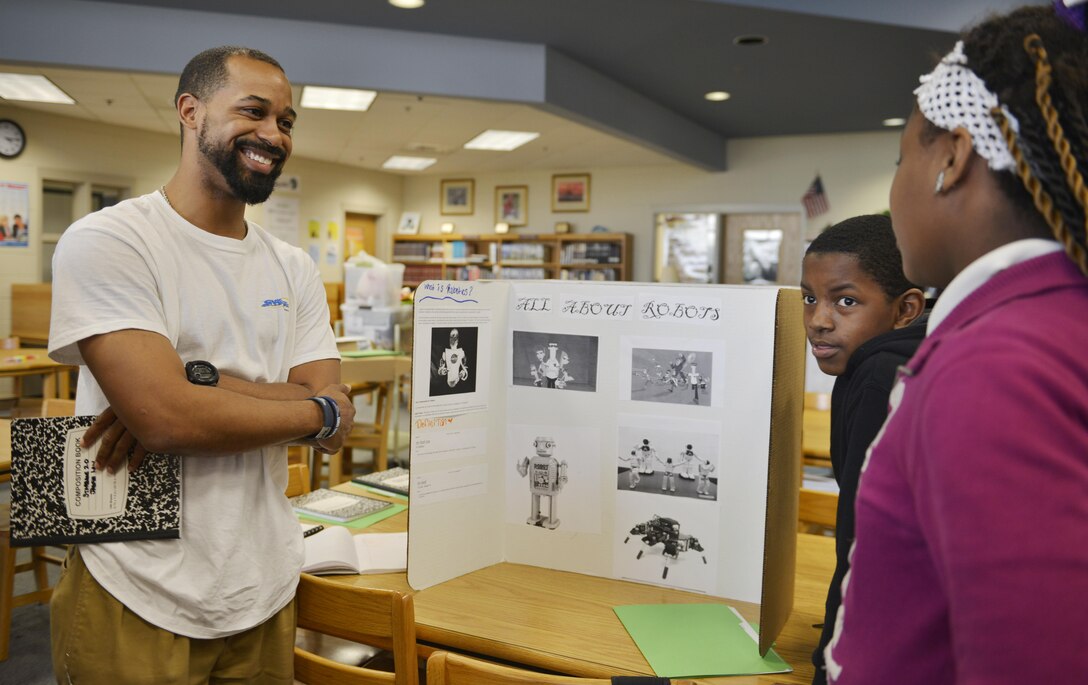 Canton Gardenhire, Corps Internal Review specialist, helps prepare sixth-grade student Jabria for a robotics presentation during a Starbase session held April 1 at DeRenne Middle School in Savannah. Gardenhire devotes two Wednesdays each month collaborating with students on projects covering physics, chemistry sciences, technology, engineering, mathematics operations and applications and STEM careers.  The Starbase program is a Department of Defense educational initiative designed to expose at-risk youth to the science, technology, engineering and math (STEM) disciplines, both on and off military installations