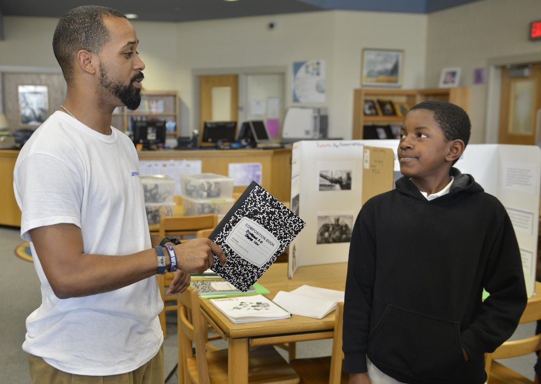 Canton Gardenhire, Corps Internal Review specialist, helps sixth-grade student Raheem map out ideas for a robotics presentation April 1 at DeRenne Middle School in Savannah. Gardenhire joined Starbase as a volunteer in the fall of 2014 collaborating with students on projects covering physics, chemistry sciences, technology, engineering, mathematics operations and applications and STEM careers. Starbase Savannah operates on local military installations and 12 K-8 private and public schools in the Savannah area