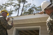 Sgt. Joshua Davis, left, and Sgt. Christopher Panko, combat engineers with 8th Engineer Support Battalion, 2nd Marine Logistics Group, hammer in the last two nails to complete the construction of a storage facility aboard Camp Lejeune, N.C., April 2, 2015. Marines with 8th ESB constructed the building for the unit’s martial arts equipment as training for an upcoming deployment. The unit will use the same skills to build schools and other facilities overseas. “I think the Marines did very well,” said Panko. “Starting at the beginning, they didn’t know very much at all – we had to teach them a lot of things, but now that we’re done with it I think they learned a lot – I learned a lot. I think everything turned out really well.” (U.S. Marine Corps photo by Cpl. Elizabeth A. Case/Released)