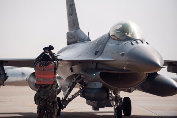 Tech Sgt. Phillip Suchicital, a 8th Aircraft Maintenance Squadron end of runway NCO in charge, marshals in an F-16 Fighting Falcon from the 140th Wing, Colorado Air National Guard, during Exercise Beverly Midnight 15-2 at Kunsan Air Base, South Korea, March 6, 2015. BM 15-2 tested Airmen on their ability to survive and operate while under the stress of simulated wartime activities, all while ensuring aircraft generate. (U.S. Air Force photo/Senior Airman Taylor Curry)