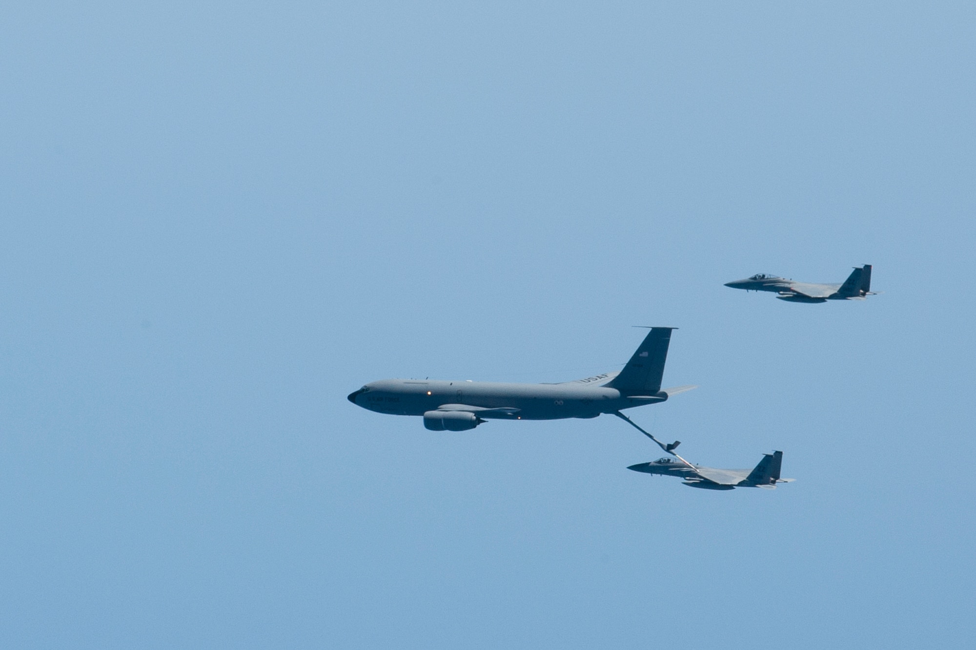 A  KC-135 Stratotanker from the 909th Air Refueling Squadron refuels an F-15C Eagle during the Forceful Tiger exercise near Okinawa, Japan, April 1, 2015. During the aerial exercise, the Stratotankers delivered 800,000 pounds of fuel to 50 aircraft. (U.S. Air Force photo/Airman 1st Class Zackary A. Henry)