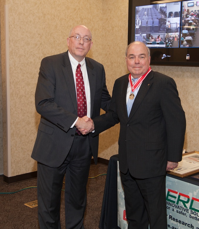 Former ERDC Deputy Director Dr. John Cullinane was presented with the Silver de Fleury Medal by ERDC Director Dr. Jeff Holland as a part of his recent retirement celebration. 