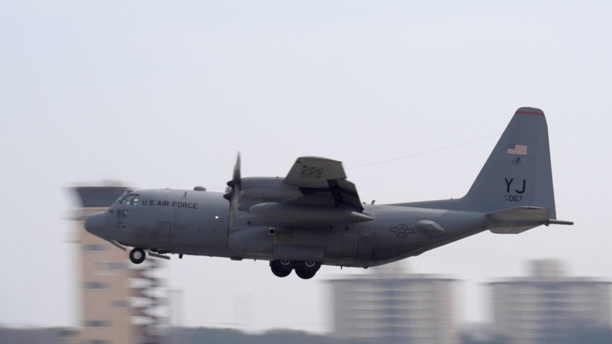 C-130 Hercules, number 2067, takes off from the flightline at Yokota Air Base, Japan, March 17, 2015. The C-130 suffered catastrophic damage to the wing section which required a complete rebuild. (U.S. Air Force photo by Senior Airman Michael Washburn/Released)