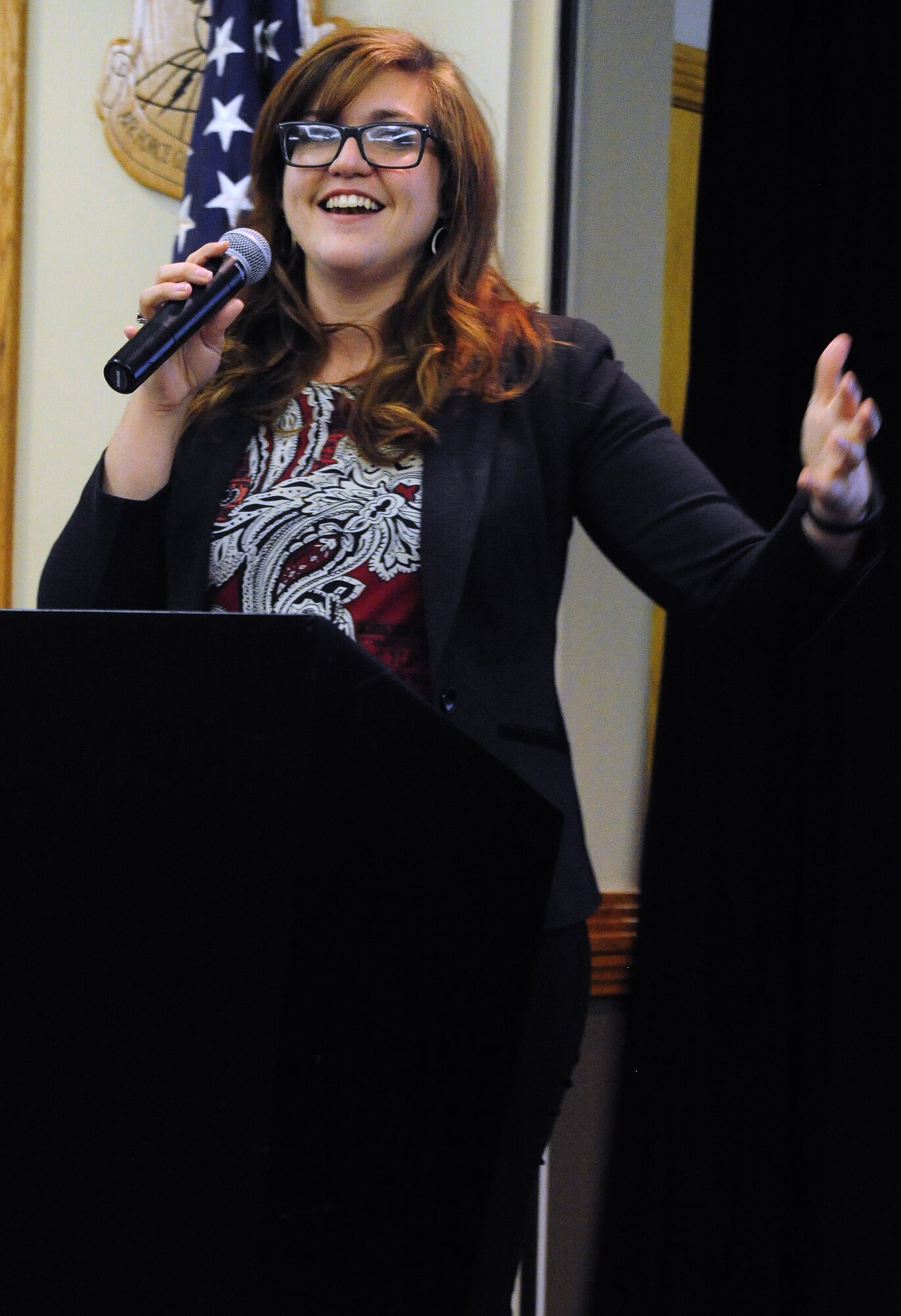 Bethanie Grace, Heroes at Home director of communications, speaks at the Heroes at Home financial education workshop at Whiteman Air Force Base, Mo., March 6, 2015. The purpose of the event was to educate Service members on options available to help pay off debt, save money and reach financial goals. (U.S. Air Force photo by Staff Sgt. Nick Wilson/Released)