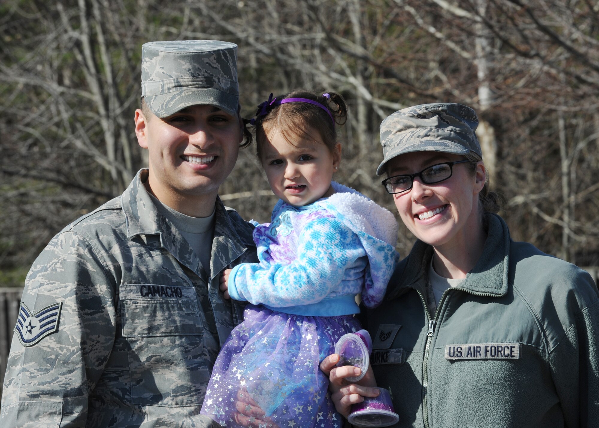 Staff Sgt(s). Jose Camacho and Jaclyn Burke, 11th Wing paralegals pose for a photo with their daughter after participating in the “Purple Parade” at Child Development Center II at Joint Base Andrews, Md., April 2, 2015. The parade symbolized the start of Month of the Military Child. (U.S. Air Force photo/Staff Sgt. Nichelle Anderson)