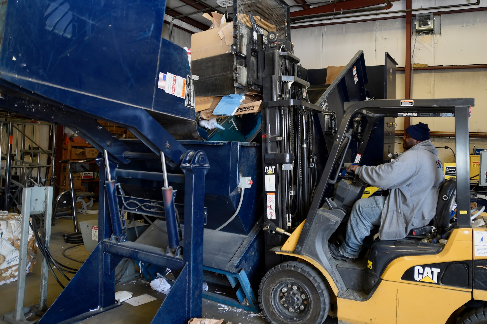 Rick Coleman, Joint Base Andrews Recycle Center lead recycling technician, loads cardboard onto a baler here, April 2, 2015. The recycling center is committed to keeping JBA green by reminding members that the Air Force mandates base units to divert 60 percent of solid waste into reusable or recycled material. (U.S. Air Force photo/Airman 1st Class Ryan J. Sonnier)