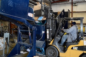 Rick Coleman, Joint Base Andrews Recycle Center lead recycling technician, loads cardboard onto a baler here, April 2, 2015. The recycling center is committed to keeping JBA green by reminding members that the Air Force mandates base units to divert 60 percent of solid waste into reusable or recycled material. (U.S. Air Force photo/Airman 1st Class Ryan J. Sonnier)