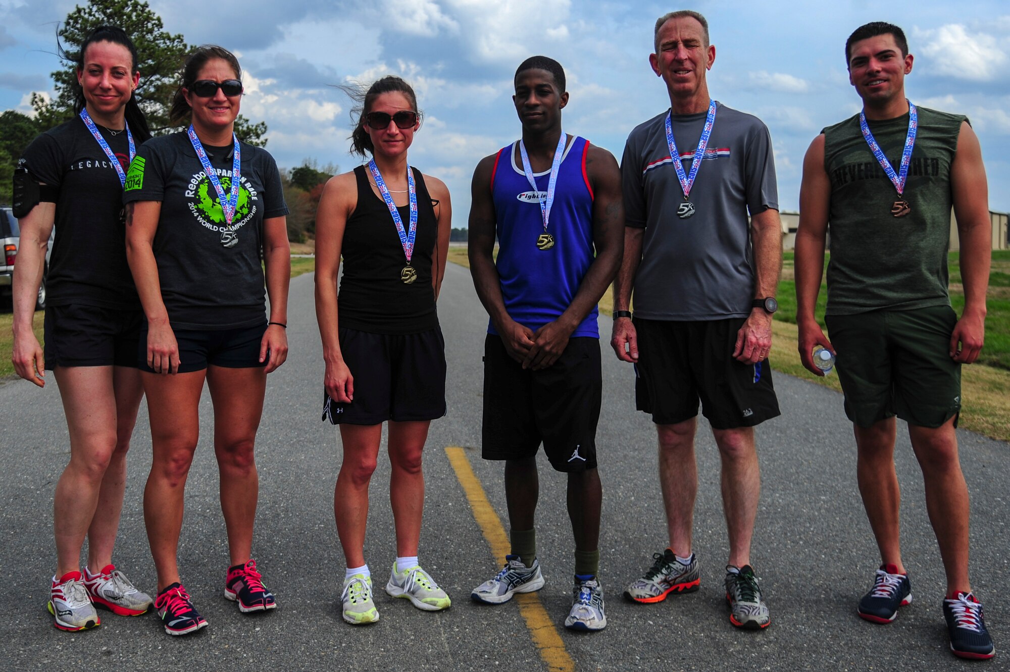 The winners of a 5K Fun Run are pictured, April 3, 2015, at Seymour Johnson Air Force Base, North Carolina. Medals were awarded to the three fastest male and female runners. (U.S. Air Force photo/Senior Airman Brittain Crolley)