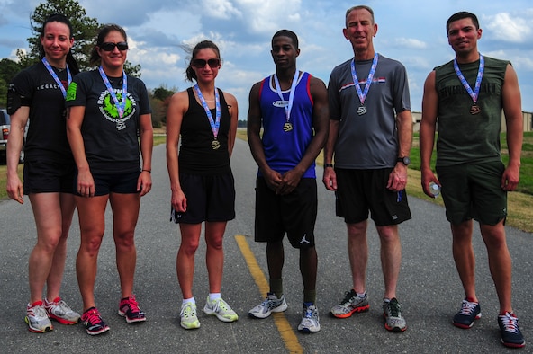 The winners of a 5K Fun Run are pictured, April 3, 2015, at Seymour Johnson Air Force Base, North Carolina. Medals were awarded to the three fastest male and female runners. (U.S. Air Force photo/Senior Airman Brittain Crolley)
