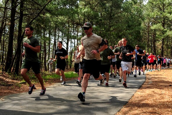 Members of Team Seymour participate in a 5K Fun Run, April 3, 2015, at Seymour Johnson Air Force Base, North Carolina. The 5K followed a scenic route along Perimeter Road and ended near the 4th Security Force Squadron building. (U.S. Air Force photo/Senior Airman Brittain Crolley)