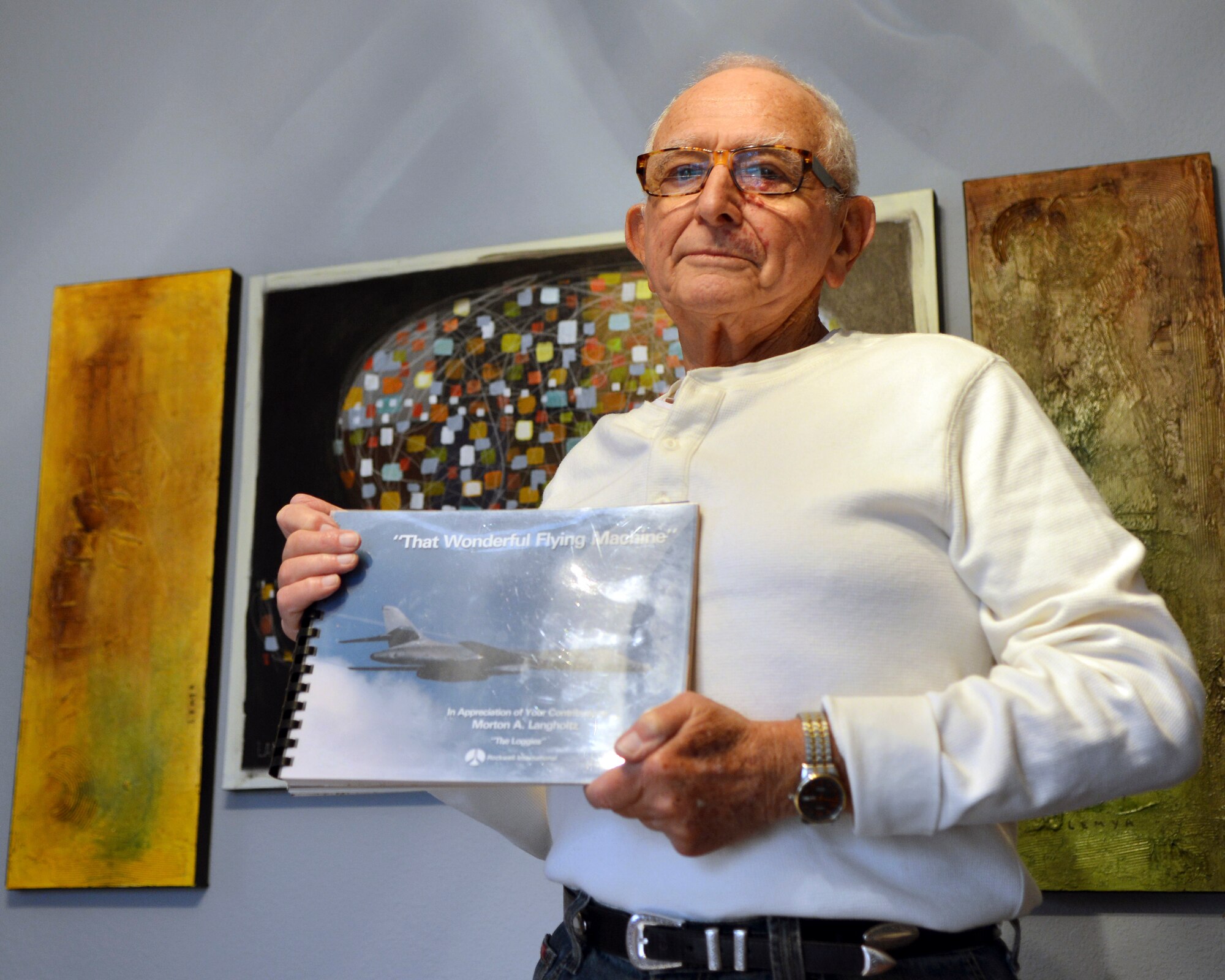 Retired U.S. Air Force Col. Morton Langholtz holds an original copy of a B-1B Lancer booklet that was dedicated to him in 1985 on March 17, 2015, in Abilene, Texas. Langholtz, the B-1 Site Activation Task Force commander from 1983-1985, helped bring the B-1 to Dyess logistically. He retired two months before the B-1’s arrival in June 29, 1985. (U.S. Air Force photo by Airman 1st Class Kedesha Pennant/Released)