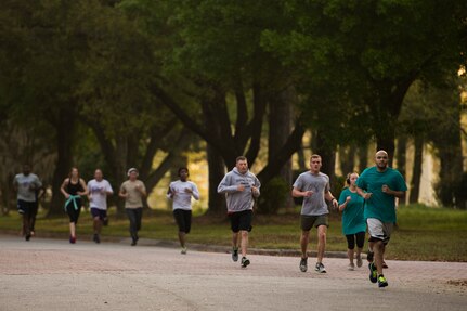 Participants of the Joint Base Charleston Sexual Assault Awareness Month 5K run down a street April 4, 2015, on JB Charleston, S.C. The month of April has been declared the official SAAM for JB Charleston with a theme of “Eliminate sexual assault: Know your part. Do your part.” Events will be held throughout the month to help promote awareness.  (U.S. Air Force photo / Airman 1st  Class Taylor Queen)