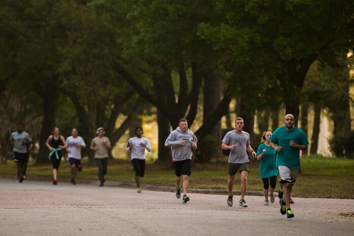 Participants of the Joint Base Charleston Sexual Assault Awareness Month 5K run down a street April 4, 2015, on JB Charleston, S.C. The month of April has been declared the official SAAM for JB Charleston with a theme of “Eliminate sexual assault: Know your part. Do your part.” Events will be held throughout the month to help promote awareness.  (U.S. Air Force photo / Airman 1st  Class Taylor Queen)