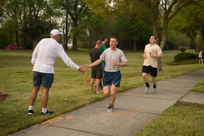 Participants of the Joint Base Charleston Sexual Assault Awareness Month 5K Walk/Run receive high-fives at the finish line April 4, 2015, JB Charleston, S.C. The month of April has been declared the official SAAM for JB Charleston with a theme of “Eliminate sexual assault: Know your part. Do your part.” Events will be held throughout the month to help promote awareness. (U.S. Air Force photo / Airman 1st  Class Taylor Queen)