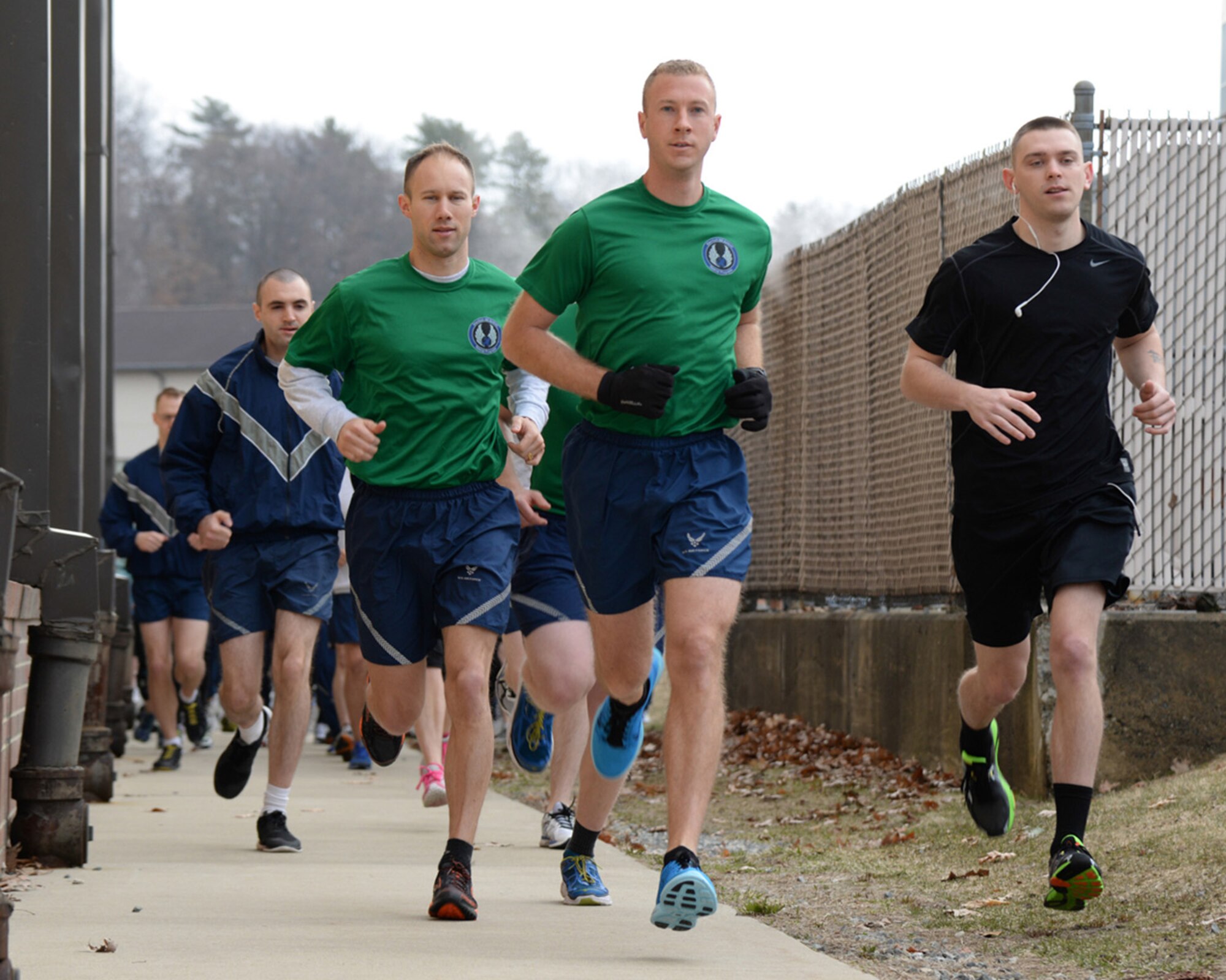 Capt. Kyle Larson (center), Maj. Brian Hans (left) and Staff Sgt. Garrison Cullers (right) lead a pack of runners at the start of the Sexual Assault Awareness Month 5K and 10K that began outside the Fitness and Sports Center April 7. More than 60 runners participated in the event hosted by the Sexual Assault Prevention and Response Program. (U.S. Air Force photo by Linda LaBonte Britt)