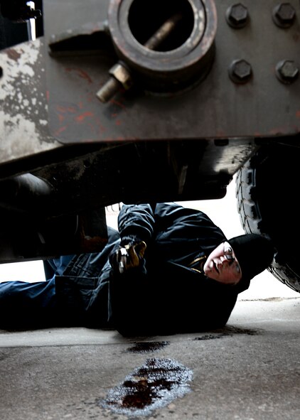Senior Airman William Evans, 28th Logistics Readiness Squadron vehicle maintenance customer service technician, repairs a leak under a snow blower vehicle at Ellsworth Air Force Base, S.D., March 17, 2015. Vehicle maintenance technicians work on everything from snow blowers and dump trucks to forklifts and aircraft tow vehicles, contributing to the bomb wing’s mission readiness. (U.S. Air Force photo by Senior Airman Anania Tekurio/Released)