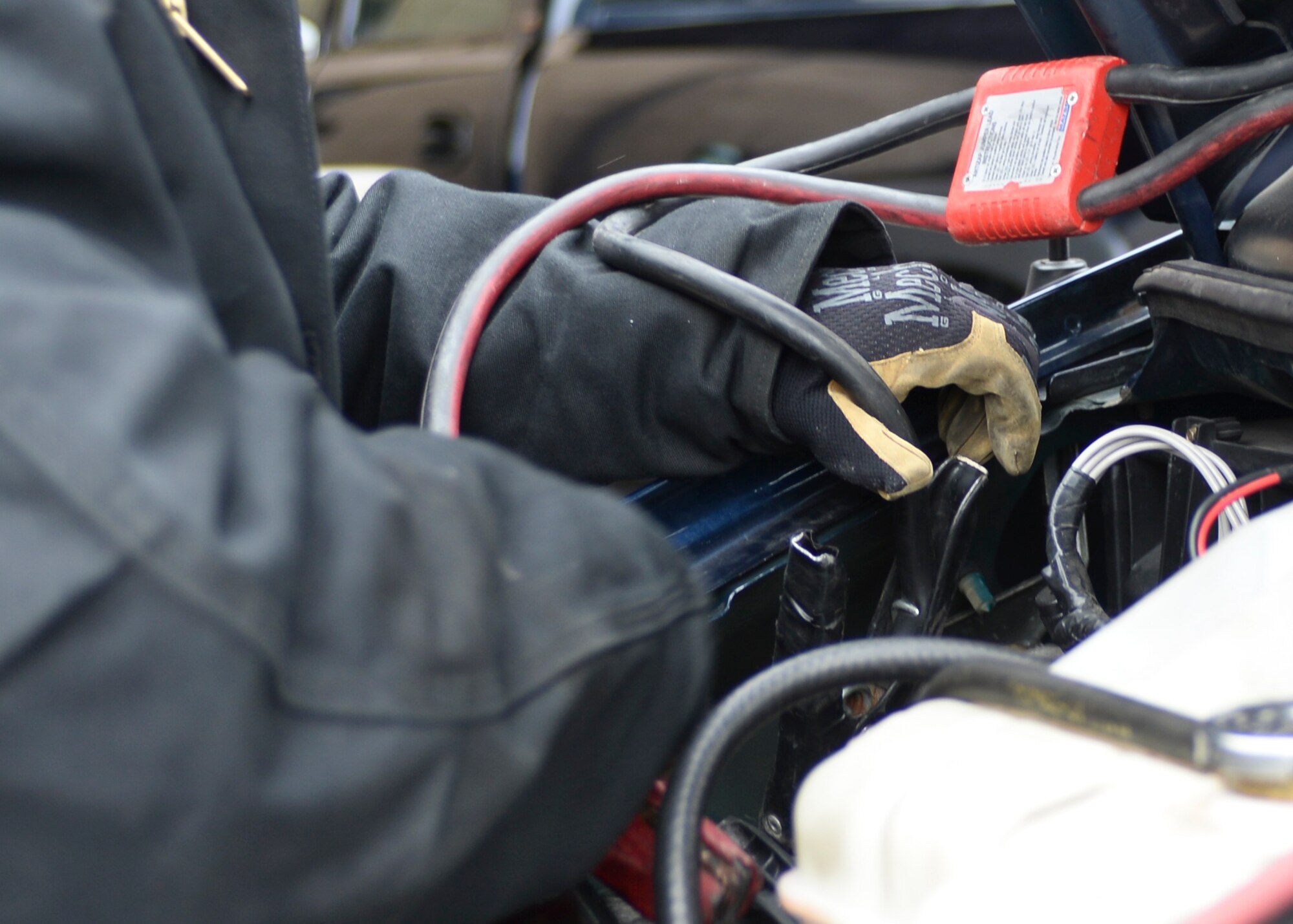 Senior Airman William Evans, 28th Logistics Readiness Squadron vehicle maintenance customer service technician, jump starts a vehicle on the flightline at Ellsworth Air Force Base, S.D., March 17, 2015. Vehicle maintenance technicians work on gasoline and diesel engines to ensure they are mission-ready. (U.S. Air Force photo by Senior Airman Anania Tekurio/Released)