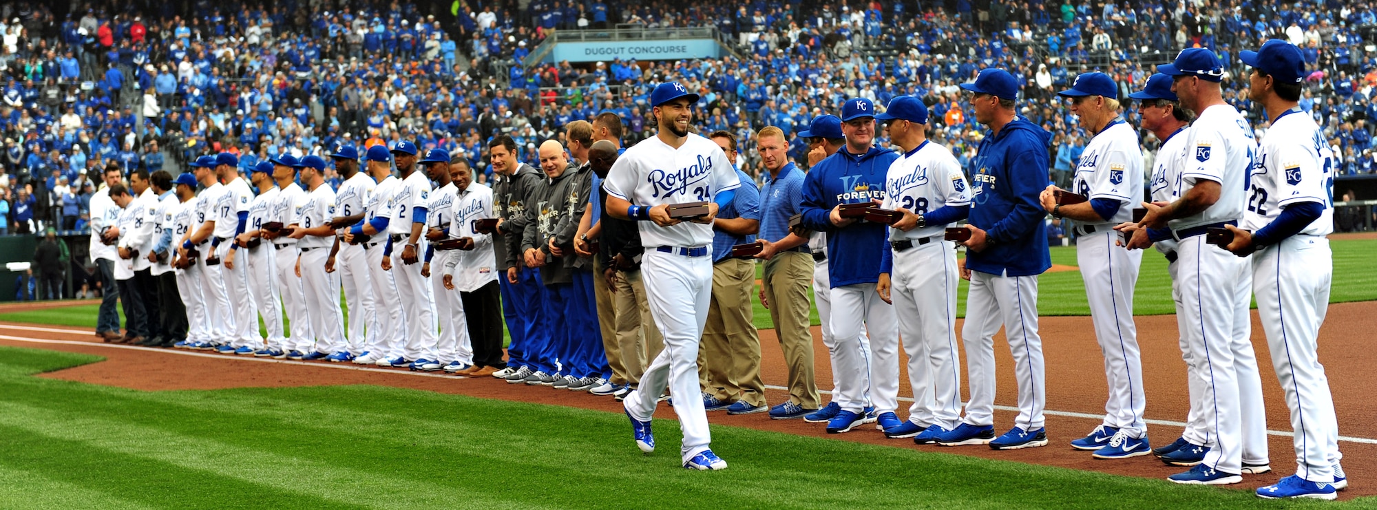 Members of the Kansas City Royals line up to receive their American League Championship rings at Kauffman Stadium April 6, 2015. After the ring ceremony, Airman from Whiteman Air Force Base, Mo. performed a flag detail accompanied by the singing of the National Anthem and a B-2 Spirit flyover. (U.S. Air Force photo by Airman 1st Class Joel Pfiester/Released)
