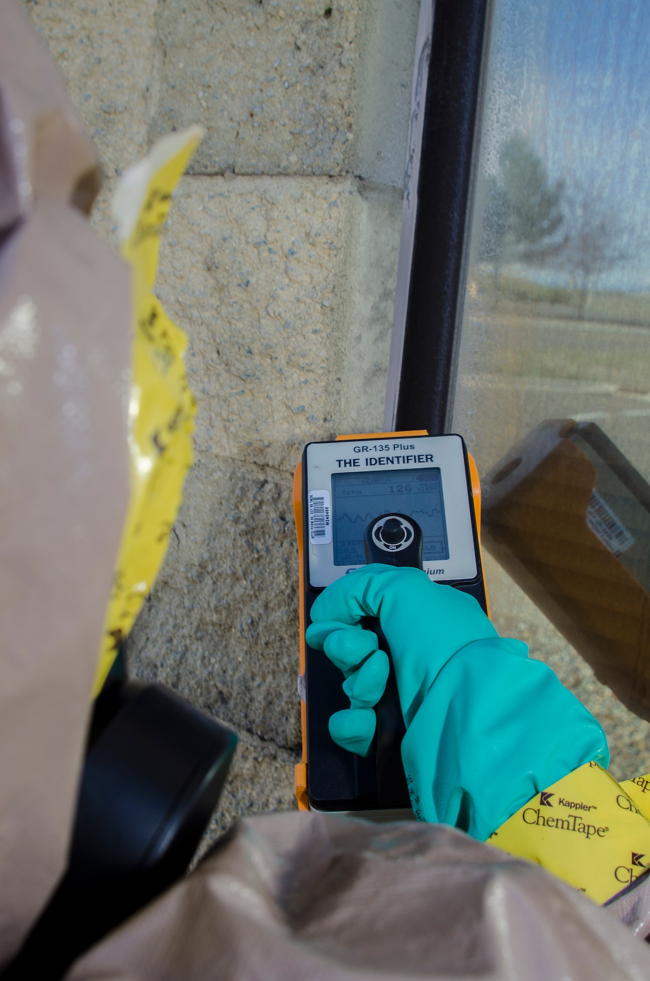 Airman 1st Class Randi Hendrix, a 92nd Civil Engineer Squadron emergency manager, scans a simulated exposed building for chemical, biological and radiological particulates during an emergency management exercise March 30, 2015, at Fairchild Air Force Base, Wash. Responders participated in an exercise that tested their response time and proficiency in real world events. (U.S. Air Force photo/Staff Sgt. Benjamin W. Stratton)