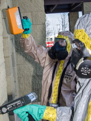 Senior Airman Kevin Klingelhoefer and Airman 1st Class Randi Hendrix, 92nd Civil Engineer Squadron emergency managers, scan a simulated exposed building for chemical, biological and radiological particulates during an emergency management exercise March 30, 2015, at Fairchild Air Force Base, Wash. Fairchild conducts similar exercises regularly to maintain a high level of preparedness to ensure the installation is always able to provide responsive, precise air refueling and operational support for the full range of military operations. (U.S. Air Force photo/Staff Sgt. Benjamin W. Stratton)