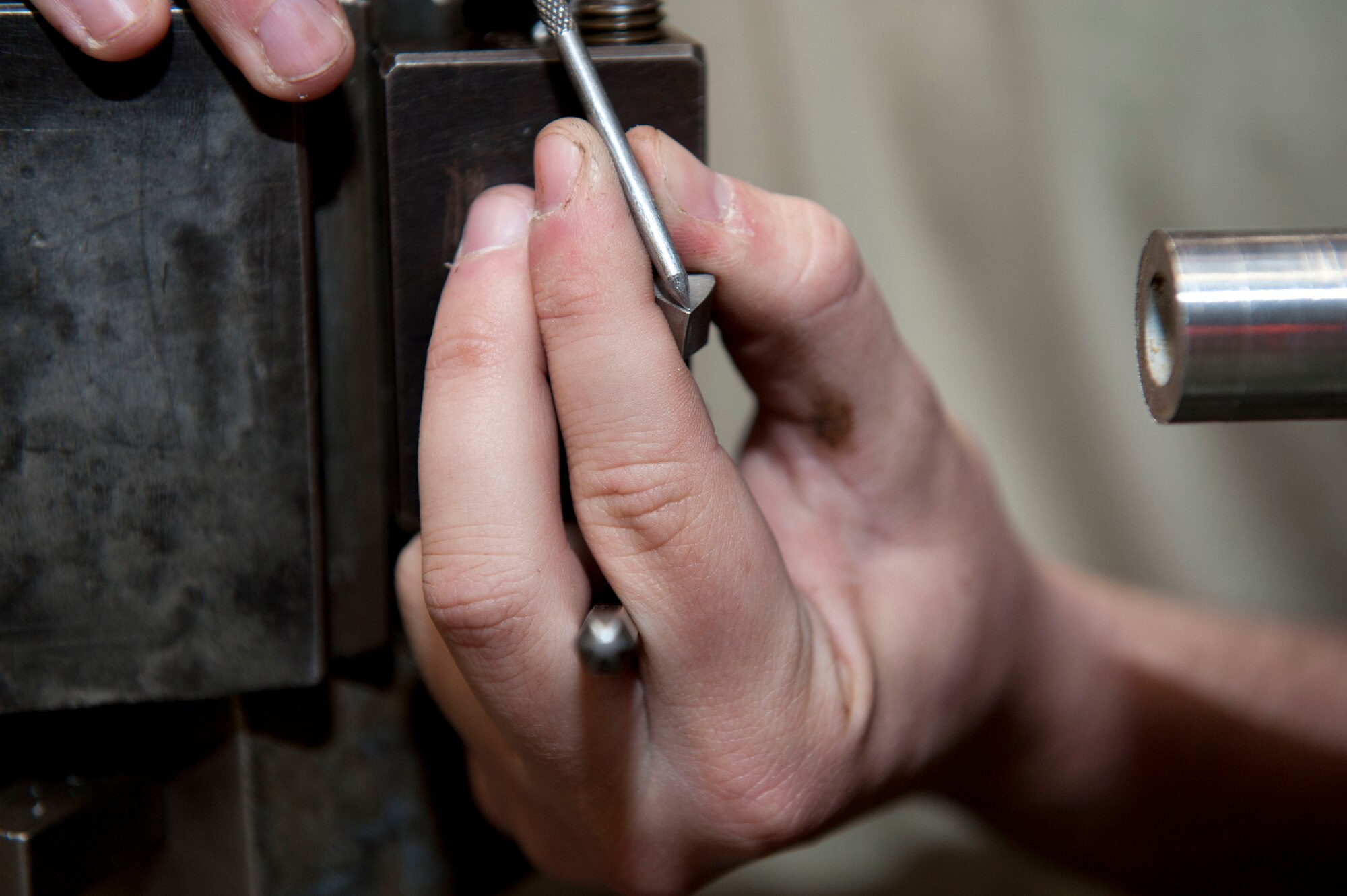 Airman 1st Class Philip Giampaolo, 49th Maintenance Squadron Aircraft Metals Technology apprentice, changes the blades on a lathe at Holloman Air Force Base, N.M. April 6, 2015. A lathe is a machine used to rotate a workpiece to perform operations such as cutting, sanding, drilling, or turning. (U.S. Air Force photo by Staff Sgt. E’Lysia A. Wray/Released)