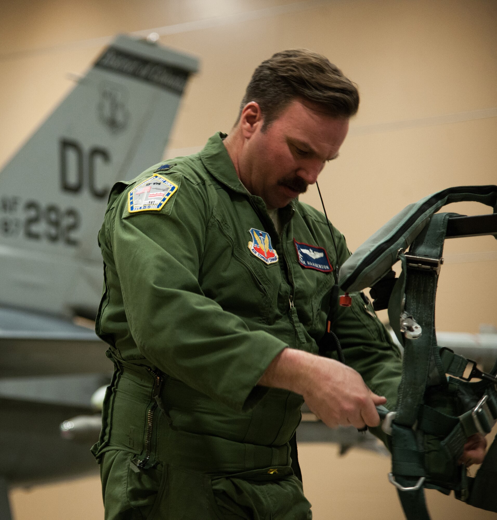 Lt. Col. Eric Haagenson, Washington, D.C., Air National Guard pilot, inspects a flight harness before a simulated alert mission at the 113th Fighter Wing’s Aerospace Control Alert Detachment, Joint Base Andrews, Md., March 30, 2015. The 113th ANG reached 5,000 alert missions, March 21, 2015, as part of an air defense system for the nation’s capital. (U.S. Air Force photo/Airman 1st Class Philip Bryant)