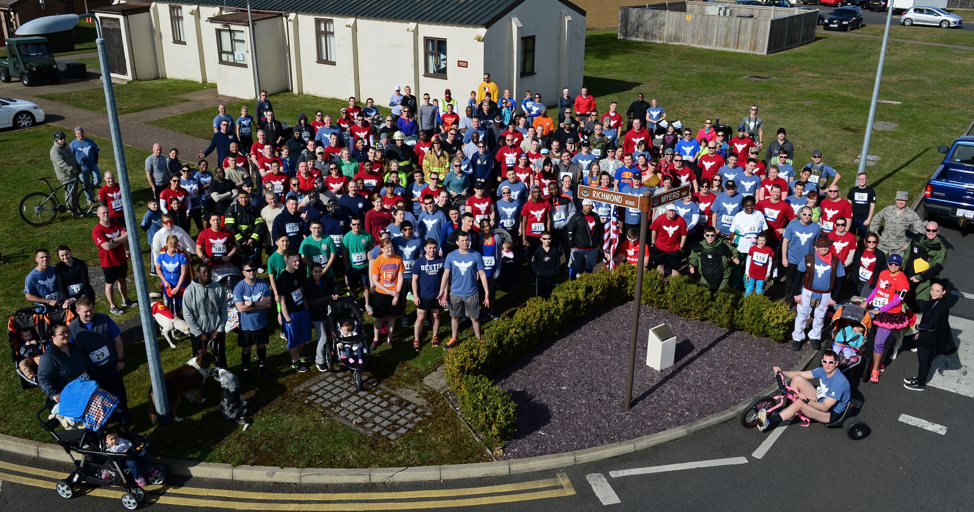 Participants of the 5th annual Phillip Myers memorial run gather around a memorial dedicated to him at Royal Air Force Lakenheath, England, April 2, 2015. Tech. Sgt. Phillip Myers was an EOD craftsman who  gave his life in the line of duty while deployed to Afghanistan April 4, 2009. (U.S. Air Force photo by Airman 1st Class Erin R. Babis/Released)