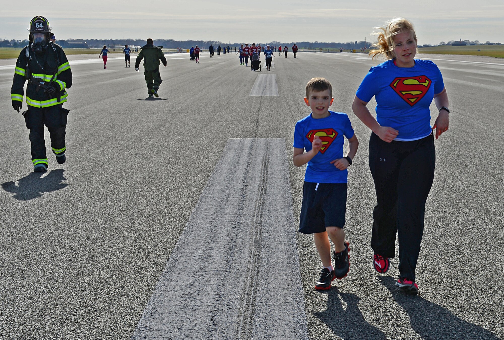 Leighann Fisher runs with her son during a 5K memorial run in memory of Tech. Sgt. Phillip Myers, an EOD craftsman, at Royal Air Force Lakenheath, England, April 2, 2015. More than 300 people participated in this year’s 5th annual Phil Myers memorial run. Leighann Fisher is the wife of Tech. Sgt. Christopher Fisher, 48th Civil Engineer Squadron NCO in charge of pavements and equipment. (U.S. Air Force photo by Airman 1st Class Erin R. Babis/Released)