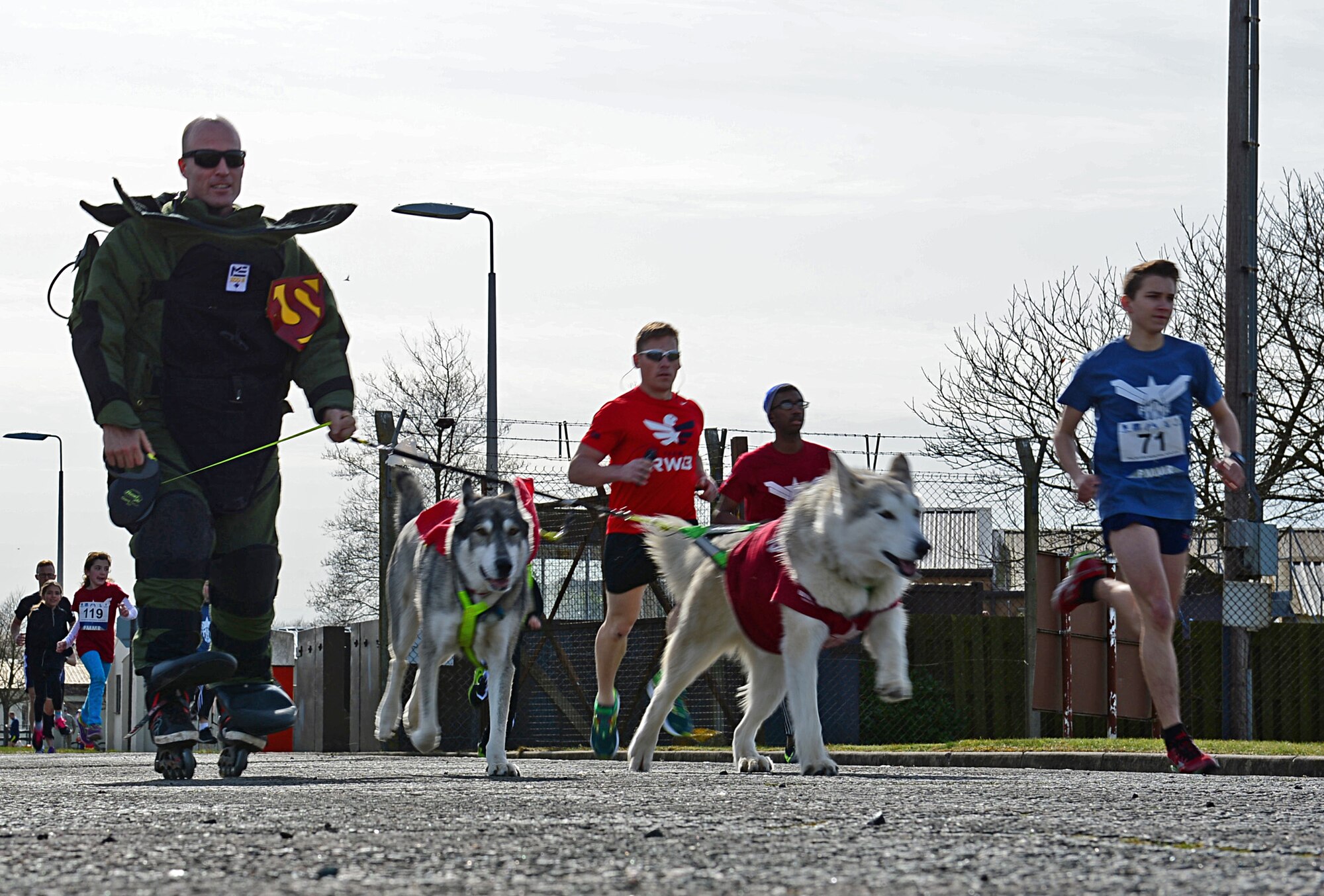 Staff Sgt. Christopher Tolley, 48th Civil Engineer Squadron explosive ordnance disposal technician, skates in a bomb suit during a 5K memorial run in memory of Tech. Sgt. Phillip Myers, an EOD craftsman, at Royal Air Force Lakenheath, England, April 2, 2015. More than 300 people participated in this year’s 5th annual Phil Myers memorial run. (U.S. Air Force photo by Airman 1st Class Erin R. Babis/Released)