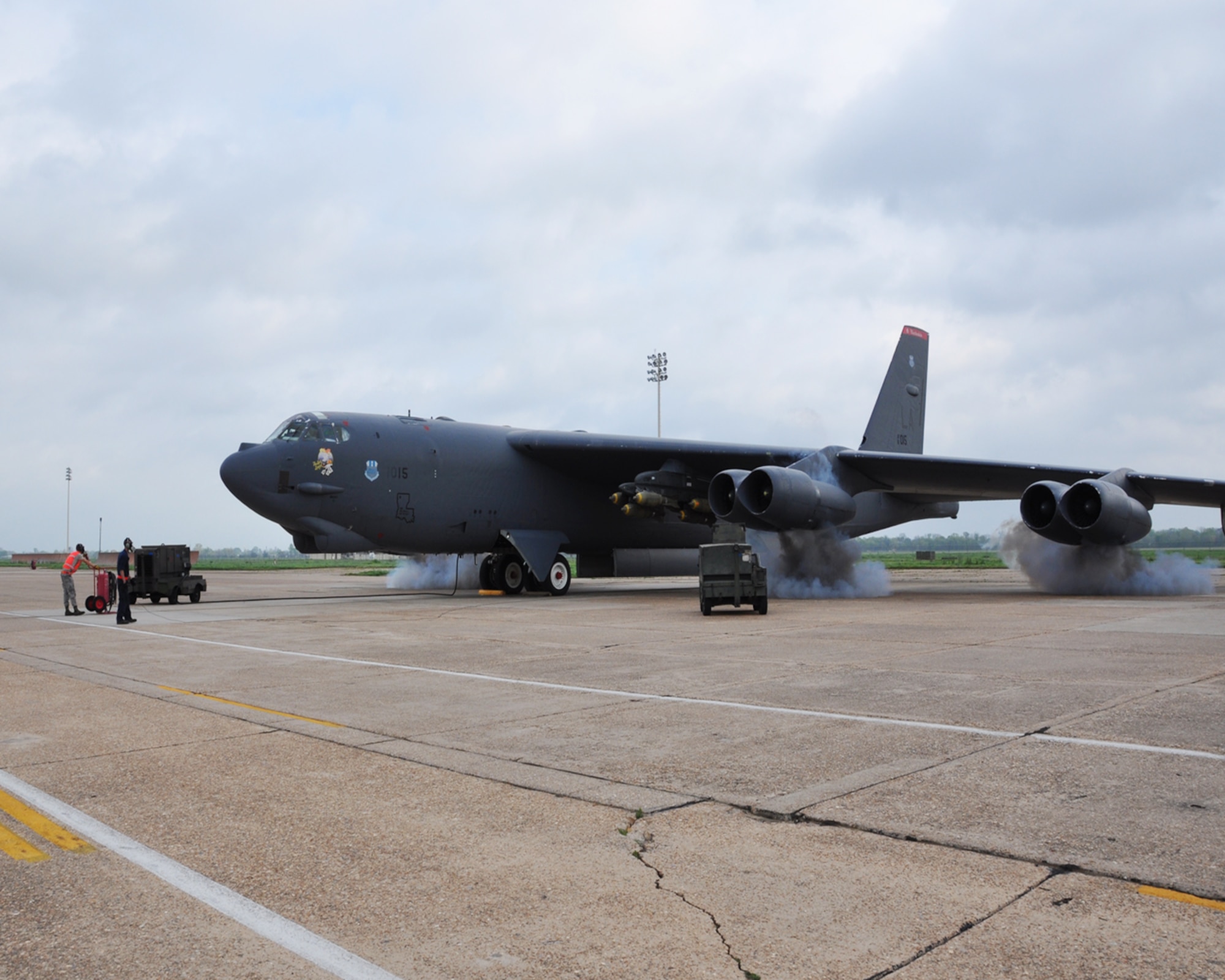 U.S. Air Force Airmen crew chiefs assigned to the 2nd Bomb Wing watch as smoke pours out of the engines of a B-52 Stratofortress manned by aircrew from the 343rd Bomb Squadron, at Barksdale Air Force Base in Louisiana, during a “cart-start” on April 2, 2015. A “cart-start” uses pyrotechnics to assist starting all eight engines at once. (U.S. Air Force photo by Master Sgt. Laura Siebert/Released)
