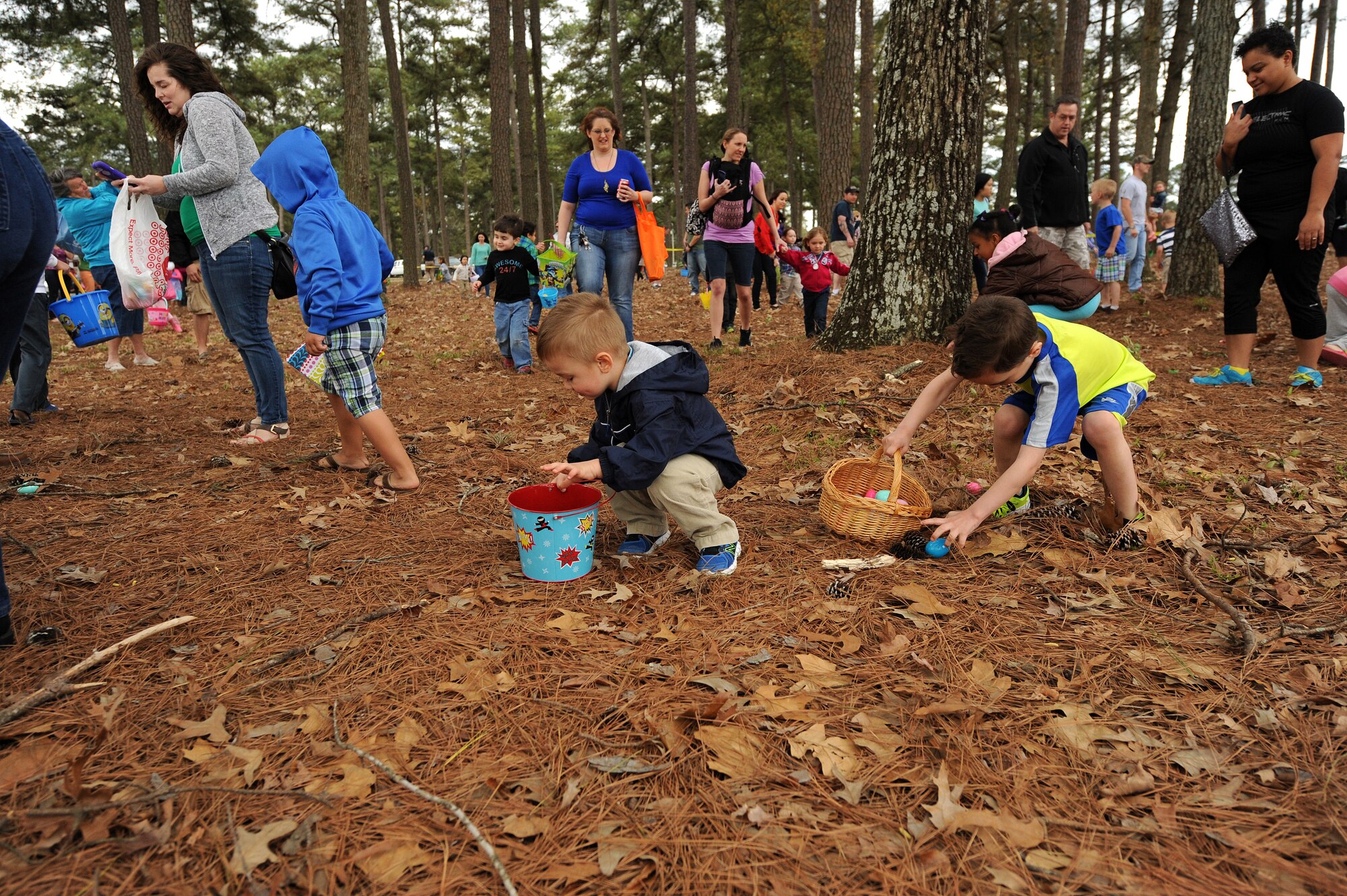 Members of Team Seymour collect eggs during the Month of the Military Child kickoff event April 4, 2015, at Seymour Johnson Air Force Base, North Carolina. The Department of Defense recognizes April as the Month of the Military Child; honoring these children for their selflessness and the sacrifices they make each day. (U.S. Air Force photo/Airman 1st Class Aaron J. Jenne)
