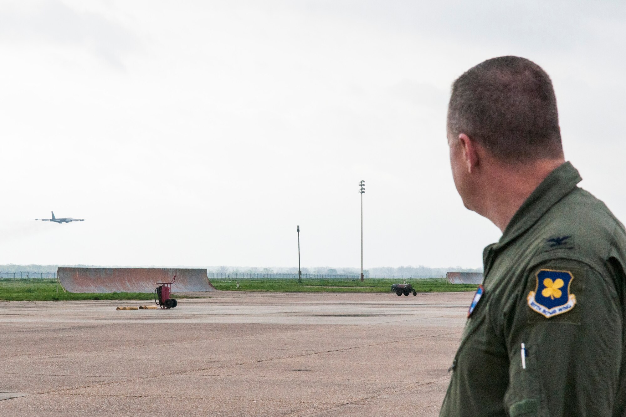 U.S. Air Force Col. Bruce Cox, commander of the 307th Bomb Wing, watches a B-52 Stratofortress take off from Barksdale Air Force Base, La. on April 2, 2015. Col. Cox visited the flight line for familiarization and to meet with aircrew and maintainers. (U.S. Air Force photo by Master Sgt. Dachelle Melville/Released)