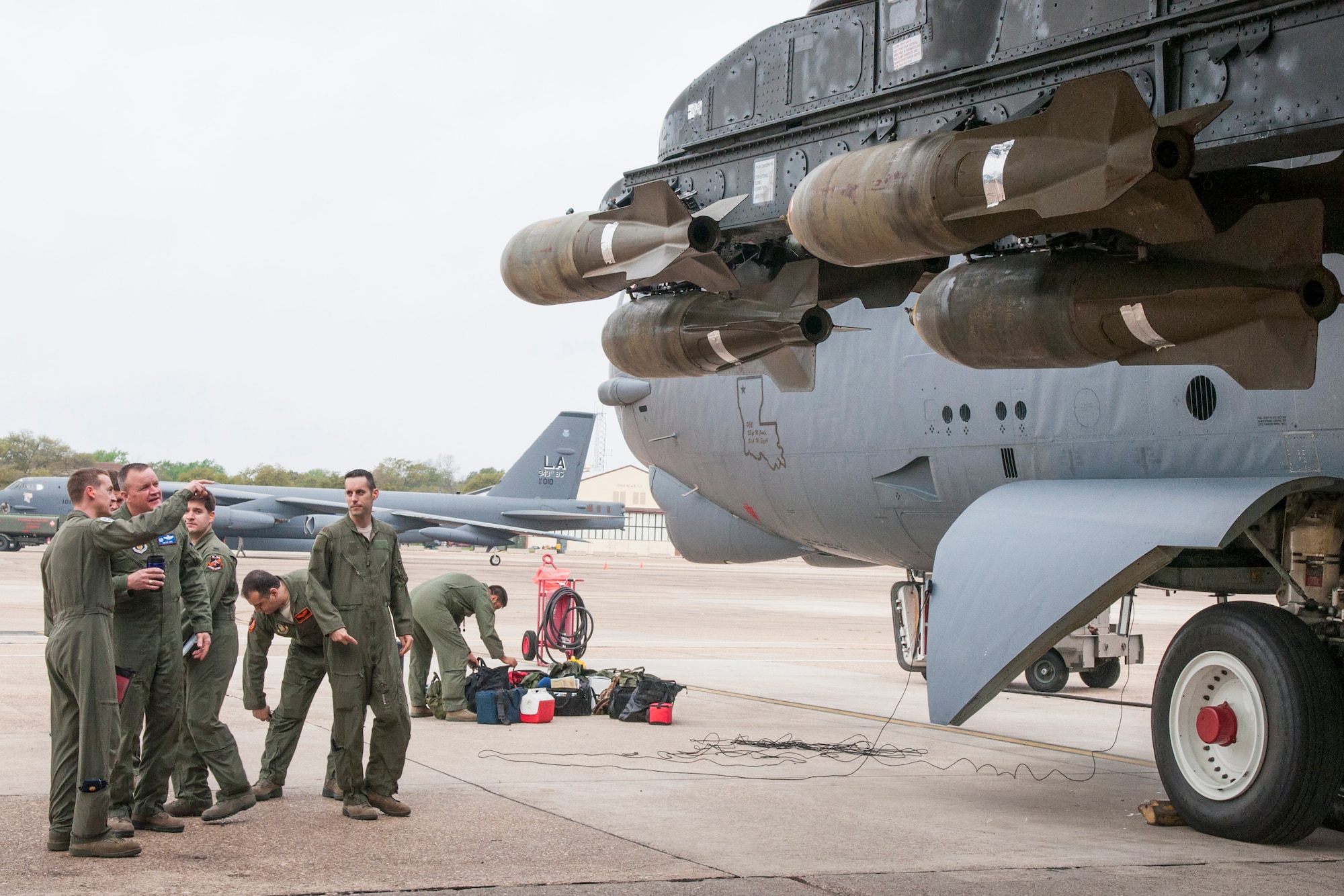Aircrew assigned to the 343rd Bomb Squadron brief U. S. Air Force Col. Bruce Cox, commander of the 307th Bomb Wing, about the live bombs loaded on their B-52 Stratofortress on April 2, 2015. The aircrew flew out of Barksdale Air Force Base, La. to complete a mission to the bombing range as part of their routine training. (U.S. Air Force photo by Master Sgt. Dachelle Melville/Released)