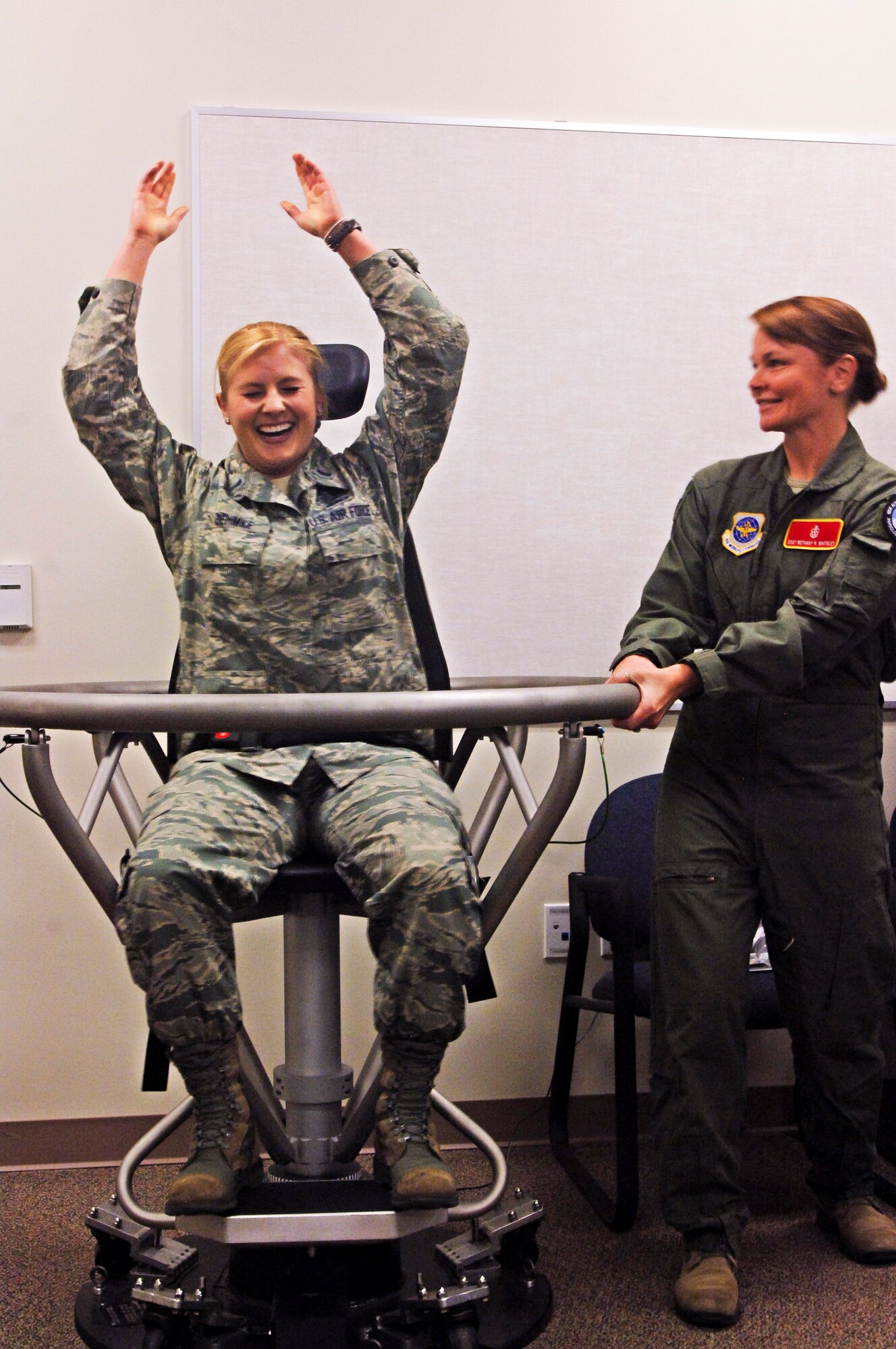 Staff Sgt. Bethany Whiteley, 92nd Aerospace Medical Squadron aerospace physiology craftsman spins 1st Lt. Evelyn Oehmke, 92nd Force Support Squadron military personnel section chief, in the Barany chair, which helps Airmen understand spatial disorientation, March 24, 2015 at Fairchild AFB, Wash. The demonstration was part of the CGO Mission Orientation Brief that gave 15 CGOs a week-long tour of the base. (U.S. Air Force photo/2nd Lt. Shelley Gregory)