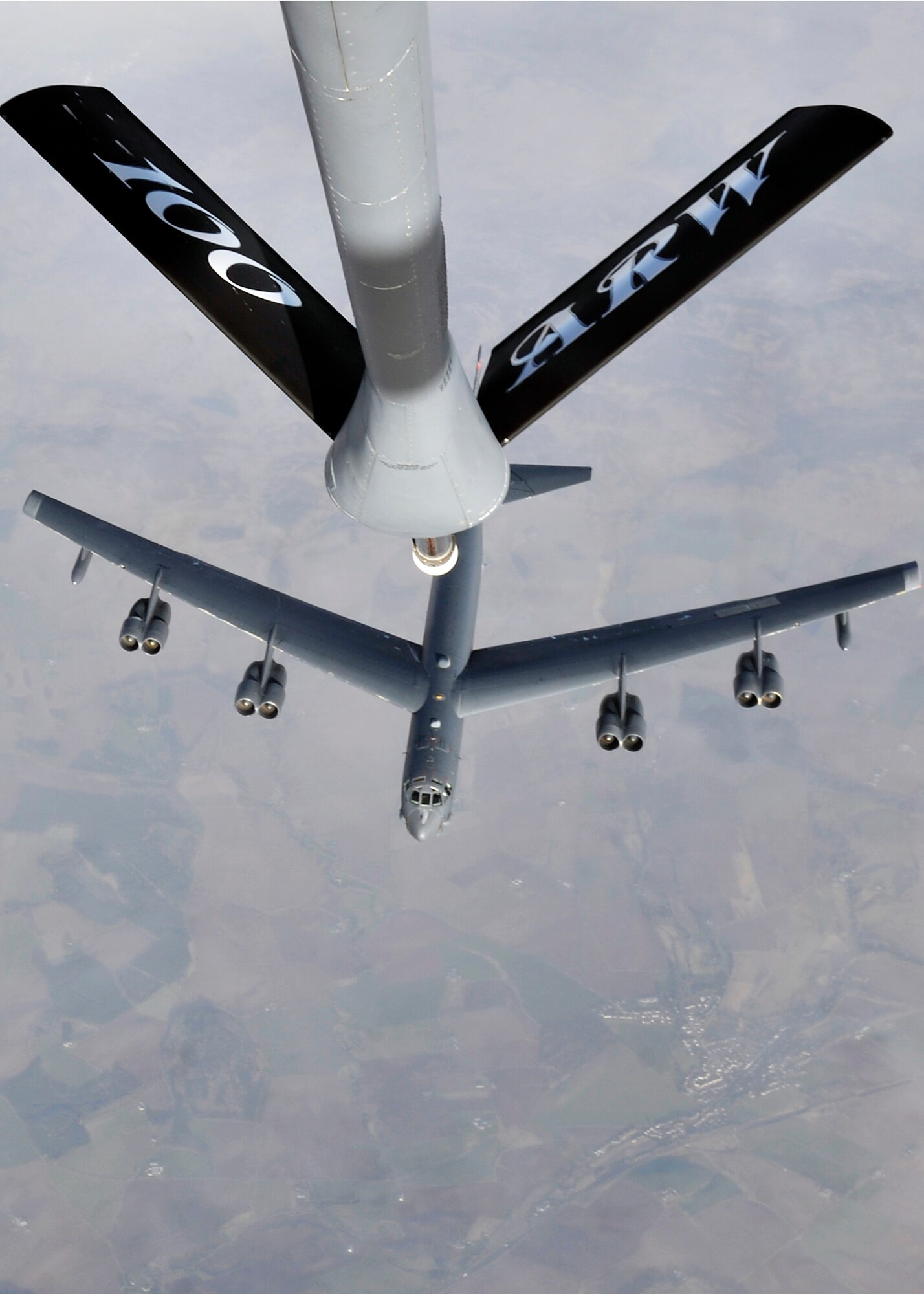 A U.S. Air Force B-52 Stratofortress from Barksdale Air Force Base, La., flies below a KC-135 Stratotanker from RAF Mildenhall, England, in support of Polar Growl April 2, 2015, over the United Kingdom. These bomber missions provide unique opportunities to integrate and train with the Untied States’ allies and partners in joint and coalition operations and exercises. (U.S. Air Force photo by Airman 1st Class Kyla Gifford/Released)