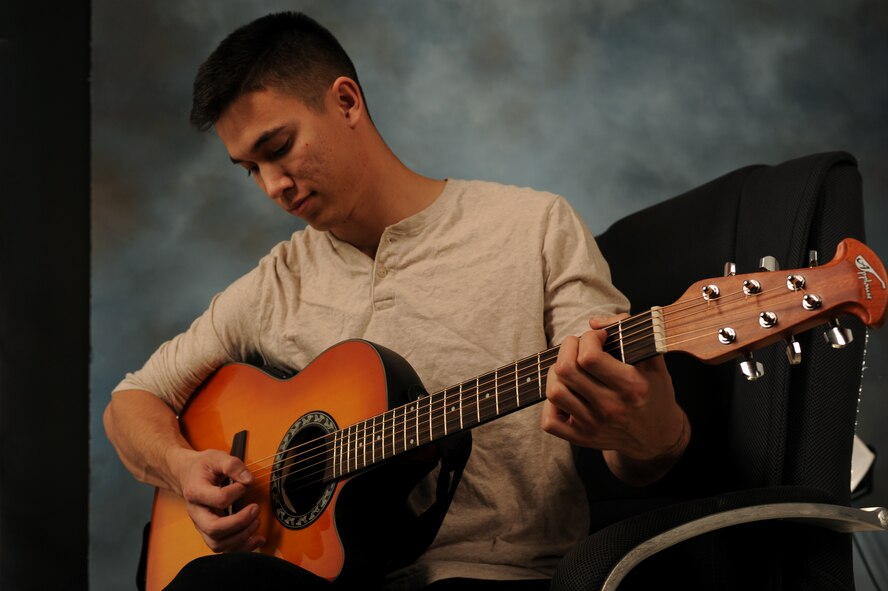 Airman 1st Class James Pratt, 28th Civil Engineer Squadron pavements and heavy equipment operator, plays acoustic guitar at Ellsworth Air Force Base, S.D., March 12, 2015.  Pratt was the number one selectee for vocal self-accompaniment during the 2015 Tops in Blue auditions, making him one of two Ellsworth Airmen selected for the entertainment unit’s upcoming 2015 tour season. Following a 60-day training period, Pratt will join the group while they travel the world, providing entertainment to audiences in deployed locations, bases and local communities nationwide. (U.S. Air Force photo by Senior Airman Hailey R. Staker/Released) 