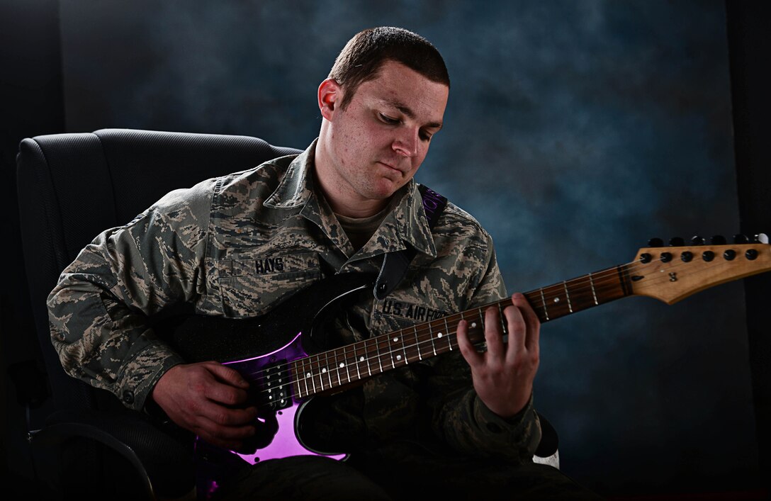 Senior Airman Trenton Hays, 37th Aircraft Maintenance Squadron sortie support technician, plays guitar at Ellsworth Air Force Base, S.D., March 9, 2015. Hays’ talent as a guitarist led to him being selected to join the Air Force’s premier entertainment unit, Tops in Blue, for its 2015 tour season. (U.S. Air Force photo by Airman 1st Class Zachary Hada/Released)
