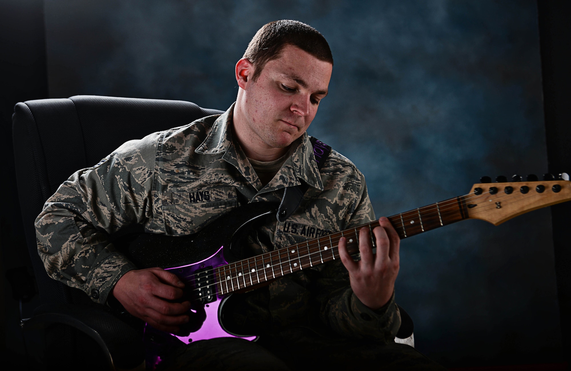 Senior Airman Trenton Hays, 37th Aircraft Maintenance Squadron sortie support technician, plays guitar at Ellsworth Air Force Base, S.D., March 9, 2015. Hays’ talent as a guitarist led to him being selected to join the Air Force’s premier entertainment unit, Tops in Blue, for its 2015 tour season. (U.S. Air Force photo by Airman 1st Class Zachary Hada/Released)