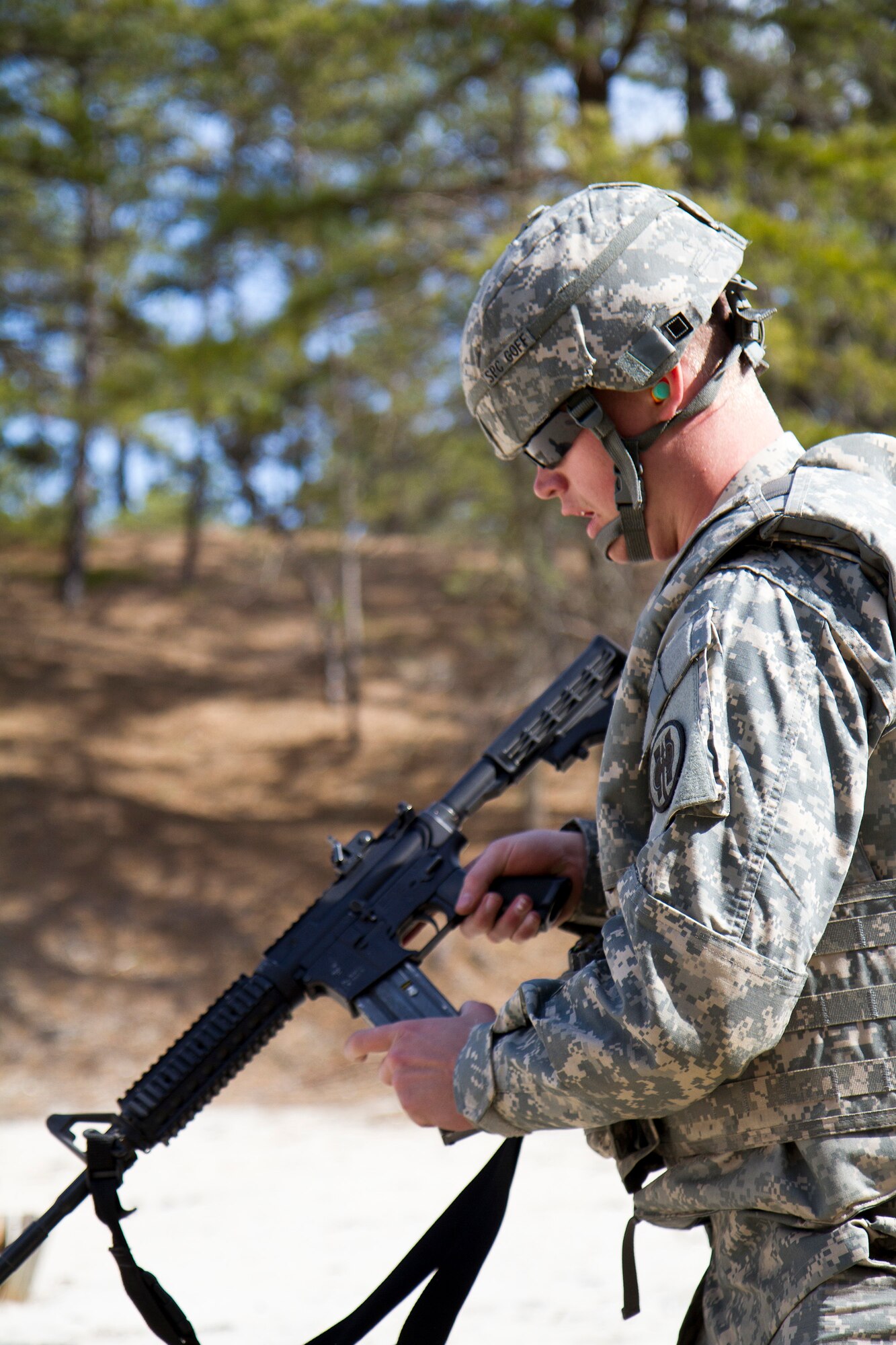 Army Reserve Spc. Michael Goff, 23, a Military Police Soldier, prepares to load his M4 carbine weapon during a reflexive fire exercise during day three of the 200th Military Police Command???s Best Warrior Competition on April 2 at Joint Base McGuire-Dix-Lakehurst, N.J. Eight warfighters are competing in the weeklong competition held March 31 ??? April 3 in a variety of physical and mental events to earn the top spot of Best Warrior for Soldier and noncommissioned officer of the year. Goff is assigned to the 366th MP Company and from Dallas. The winners will compete at the Army Reserve Best Warrior Competition held in May. The 200th MPCOM is the largest Department of Defense law enforcement organization, with nearly 14,000 Soldiers living in 44 states. (Army Reserve photo by Sgt. 1st Class Mark Bell/released)