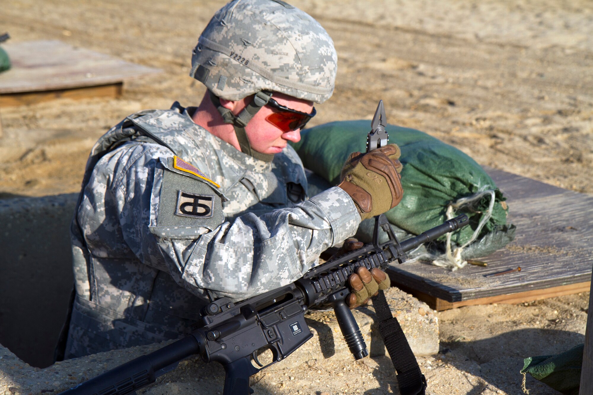 Army Reserve Sgt. Duane Van Holsbeke, 28, from The Colony, Texas, adjusts the front sights of his M4 carbine weapon during the zero process of day three of the 200th Military Police Command???s Best Warrior Competition on April 2 at Joint Base McGuire-Dix-Lakehurst, N.J. Eight warfighters are competing in the weeklong competition held March 31 ??? April 3 in a variety of physical and mental events to earn the top spot of Best Warrior for Soldier and noncommissioned officer of the year. Van Holsbeke is a Military Police Soldier assigned to the 366th MP Company. The winners will compete at the Army Reserve Best Warrior Competition held in May. The 200th MPCOM is the largest Department of Defense law enforcement organization with nearly 14,000 Soldiers living in 44 states. (Army Reserve photo by Sgt. 1st Class Mark Bell/released)