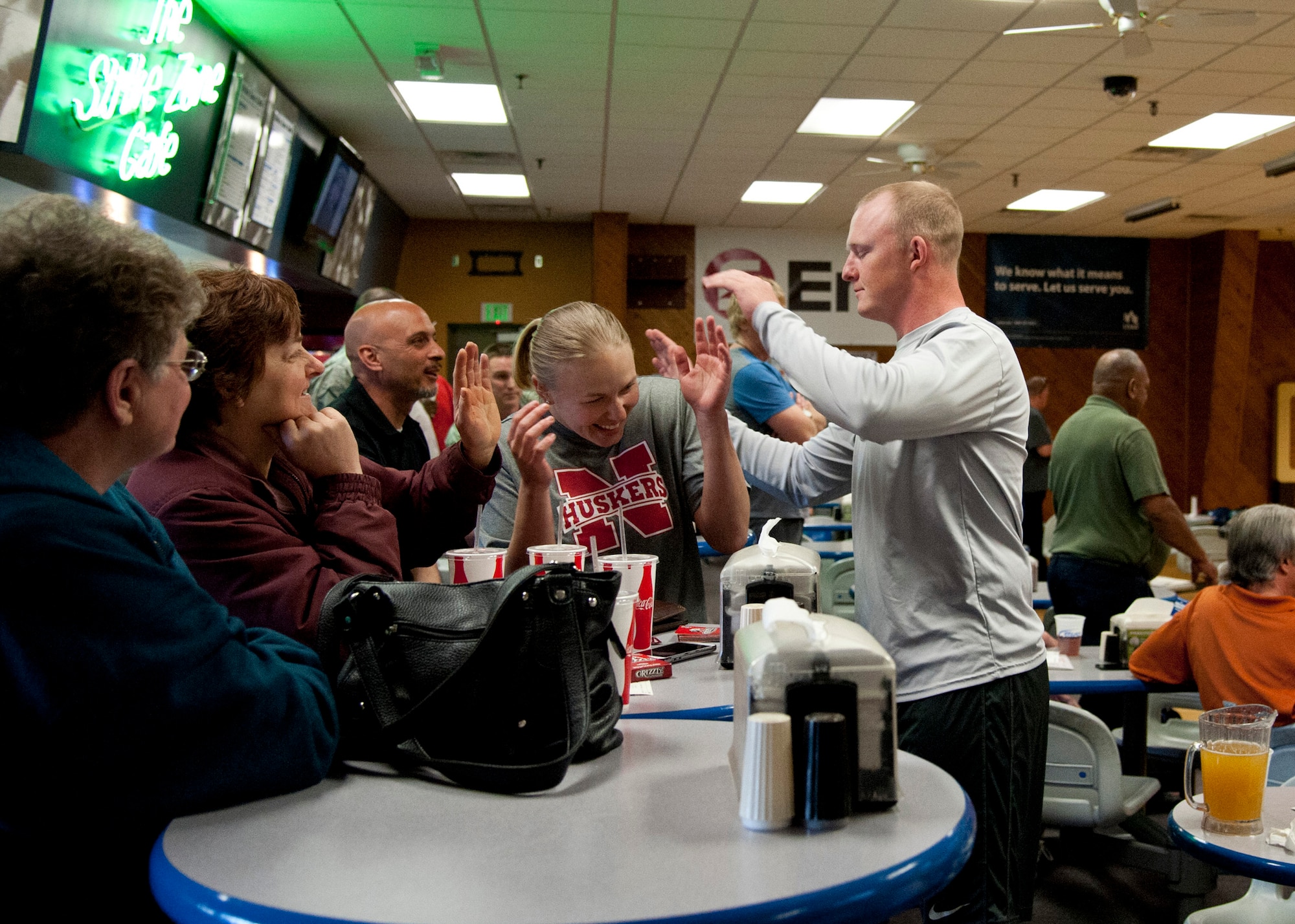 PETERSON AIR FORCE BASE, Colo. – Staff Sgt. Kyle Kelly, 21st Communications Squadron, picks on his sister, Staff Sgt. Kayla Miller, 21st Operations Support Squadron, during a bowling league game at the Peterson bowling alley April 1, 2015. Kelly and Miller are stationed together for the second time in their careers and are on the same bowling team, 9 Pin Power. (U.S. Air Force photo by Senior Airman Tiffany DeNault)