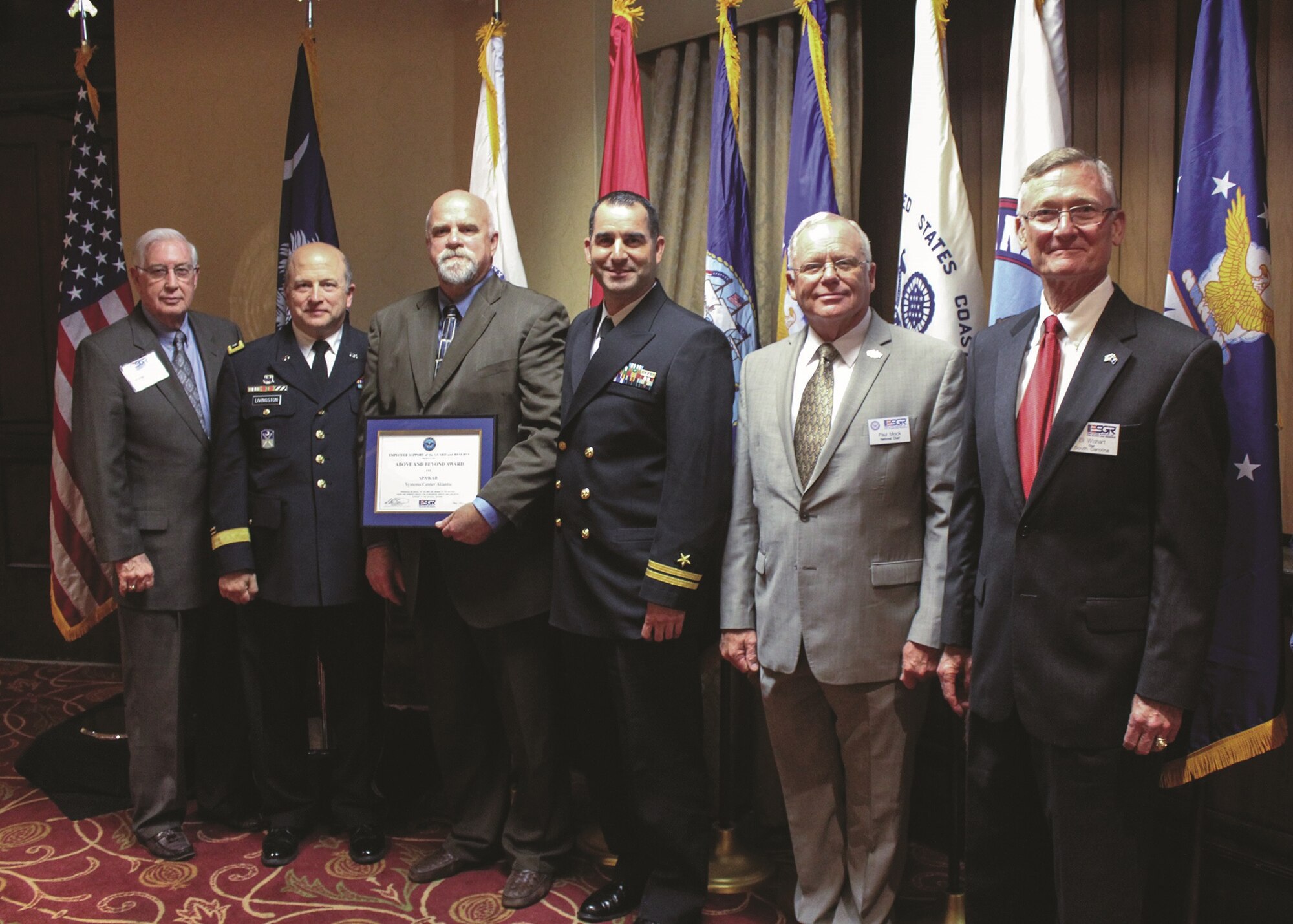 (From left to right) Maj.Gen. (ret.) George Goldsmith, U.S. Army Reserve; S.C Adjutant General Maj.Gen. Robert E. Livingston Jr.; Lonnie Cowart, SSC Atlantic director of Corporate Communications and Public Affairs; Tommy Groves, SSC Atlantic Corporate Communications and Public Affairs chief of media; Maj.Gen. (ret.) Paul E. Mock, national chair of the Employer Support of the Guard and Reserve; and S.C. ESGR State Chairman Eli Wishart pose at the 2015 ESGR awards banquet in Columbia, S.C., on March 13, 2015. SSC Atlantic was awarded the Above and Beyond award for their support as a patriotic employer in South Carolina. Cower accepted the award on behalf of SSC Atlantic. 
