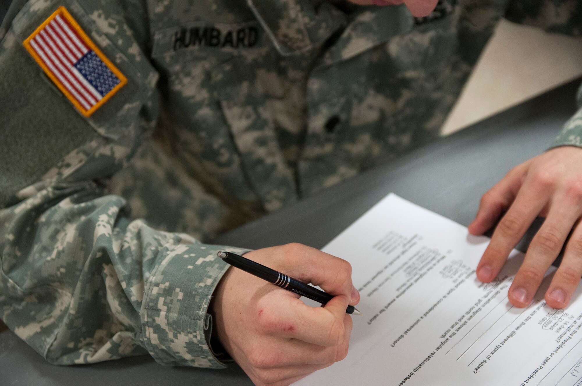 Army Reserve Spc. Chance Humbard, 21, from Waldorf, Md., works through a written exam during day one of the 200th Military Police Command???s Best Warrior Competition on March 31 at Joint Base McGuire-Dix-Lakehurst, N.J. Eight warfighters are competing in the weeklong competition held March 31 ??? April 3 in a variety of physical and mental events to earn the top spot of Best Warrior for Soldier and noncommissioned officer of the year. Humbard is supply specialist assigned to Headquarters and Headquarters Company, 400th Military Police Battalion, based at Fort Meade, Md. The winners will compete at the Army Reserve Best Warrior Competition held in May. The 200th MPCOM is the largest Department of Defense law enforcement organization, with nearly 14,000 Soldiers living in 44 states. (Army Reserve photo by Sgt. Gina Russell/released)