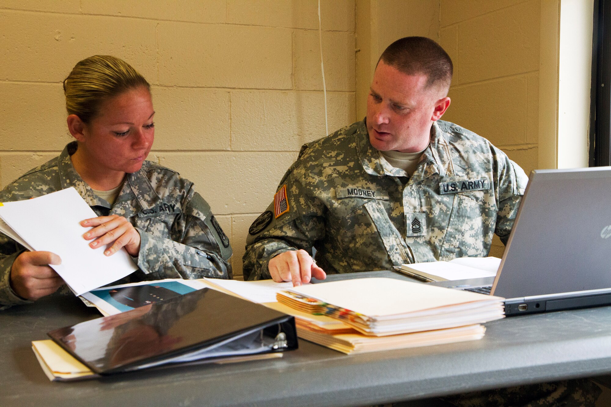 Master Sgt. Jeffery Mooney and Staff Sgt. Sarah Haas review packets of warfighters competing in the 200th Military Police Command???s Best Warrior Competition during day one of the week-long competition held at Joint Base McGuire-Dix-Lakehurst, N.J, May 31-April 3. Eight competitors competed in a variety of physical and mental events to earn the top spot of Best Warrior for Soldier and noncommissioned officer of the year. Mooney is assigned to the Headquarters and Headquarters Company, 200th MPCOM , based at Fort Meade, Maryland, and Hass is assigned to the 374th MP Company in York, Pennsylvania. The winners will compete at the Army Reserve Best Warrior Competition held in May. The 200th MPCOM is the largest Department of Defense law enforcement organization with nearly 14,000 Soldiers living in 44 states. (Army Reserve photo by Sgt. 1st Class Mark Bell/released)