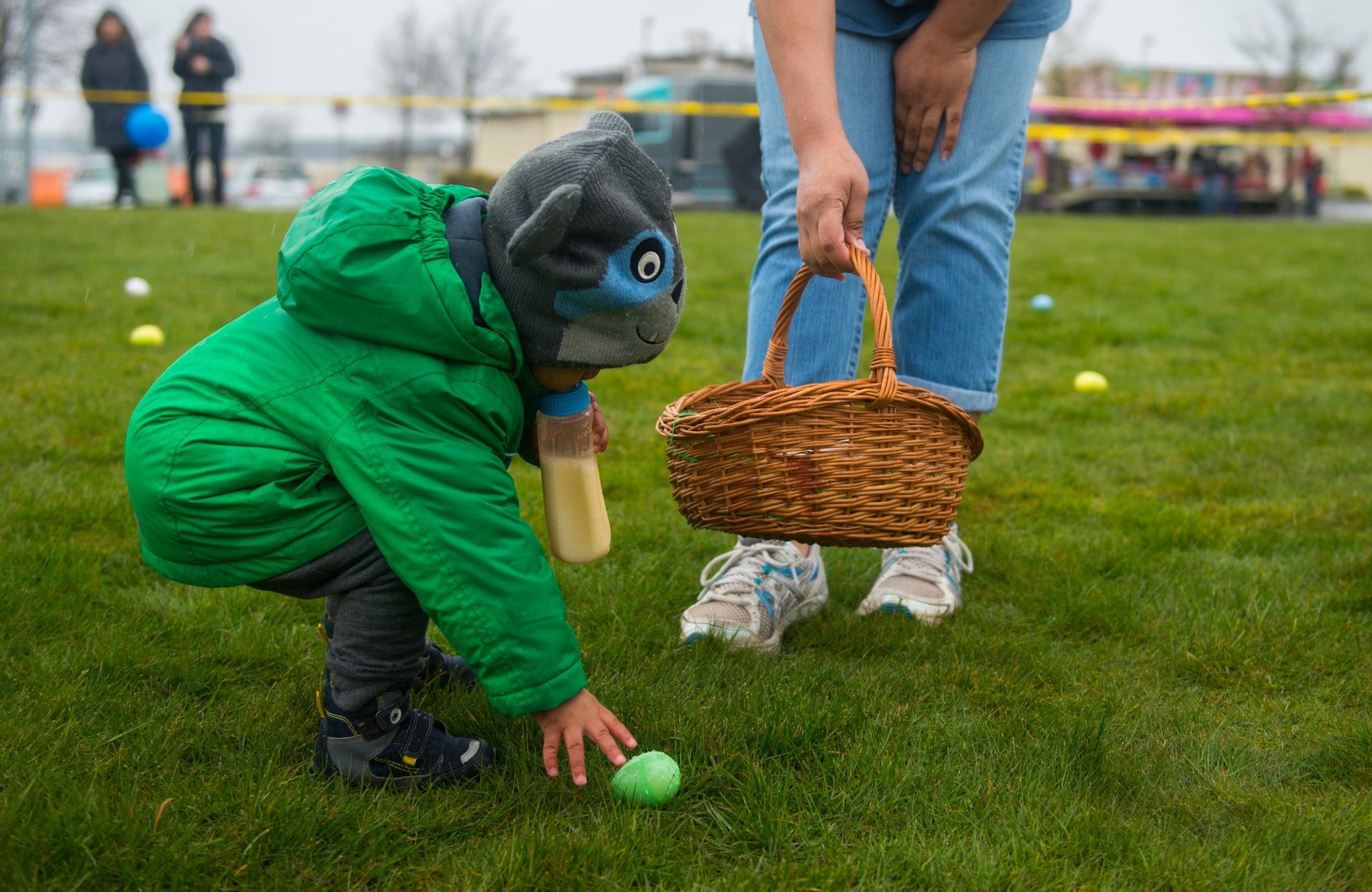 A child reaches for a plastic egg while participating in an Easter egg hunt on the grass field outside Club Eifel at Spangdahlem Air Base, Germany, April 4, 2015. Parents of children the ages 3 and younger could help in the egg hunt. (U.S. Air Force photo by Airman 1st Class Luke Kitterman/Released)
 
