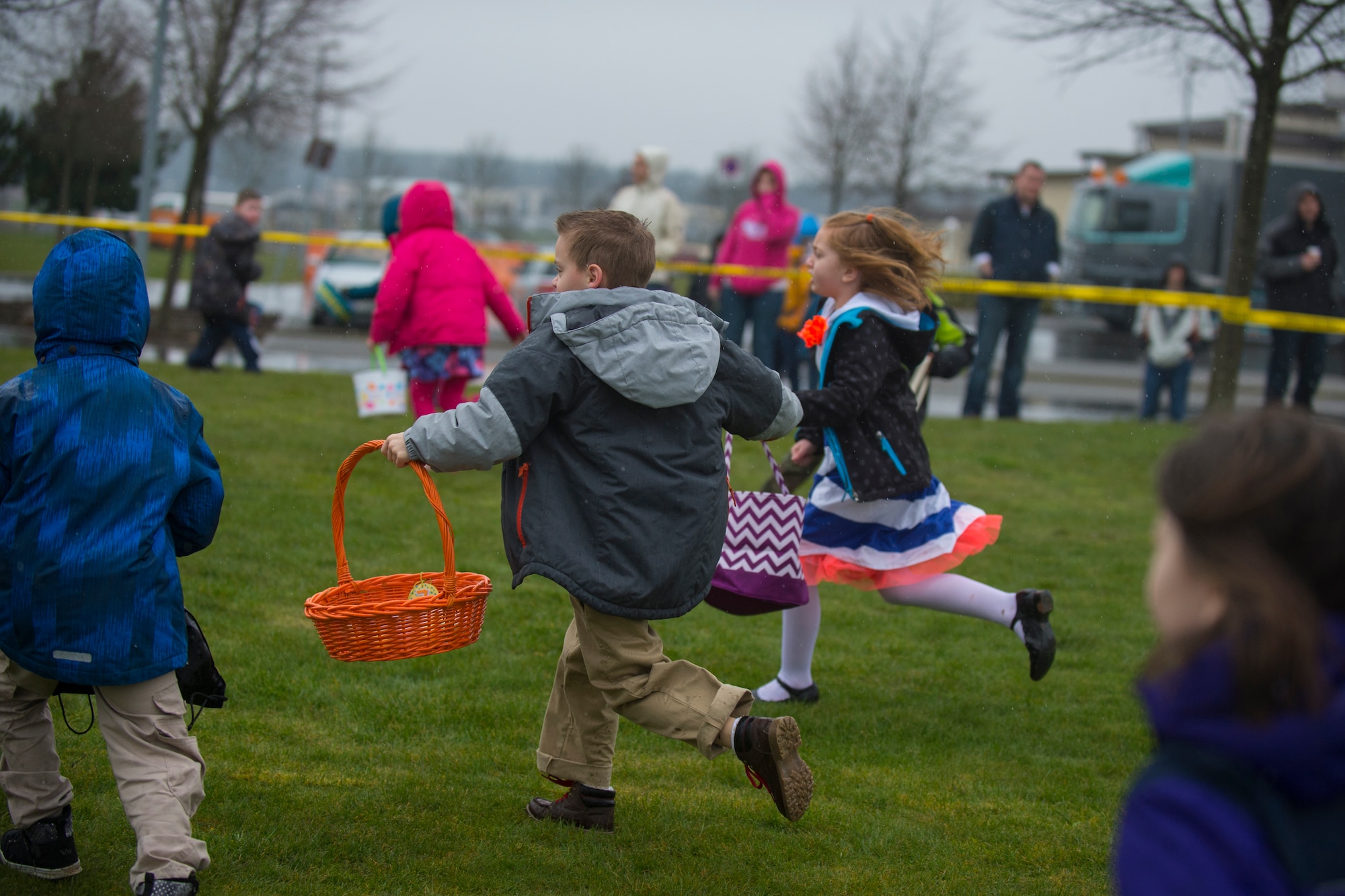 Children search for plastic eggs during an Easter egg hunt on the grass field outside Club Eifel at Spangdahlem Air Base, Germany, April 4, 2015. There were multiple egg hunts for the different age groups participating. (U.S. Air Force photo by Airman 1st Class Luke Kitterman/Released)